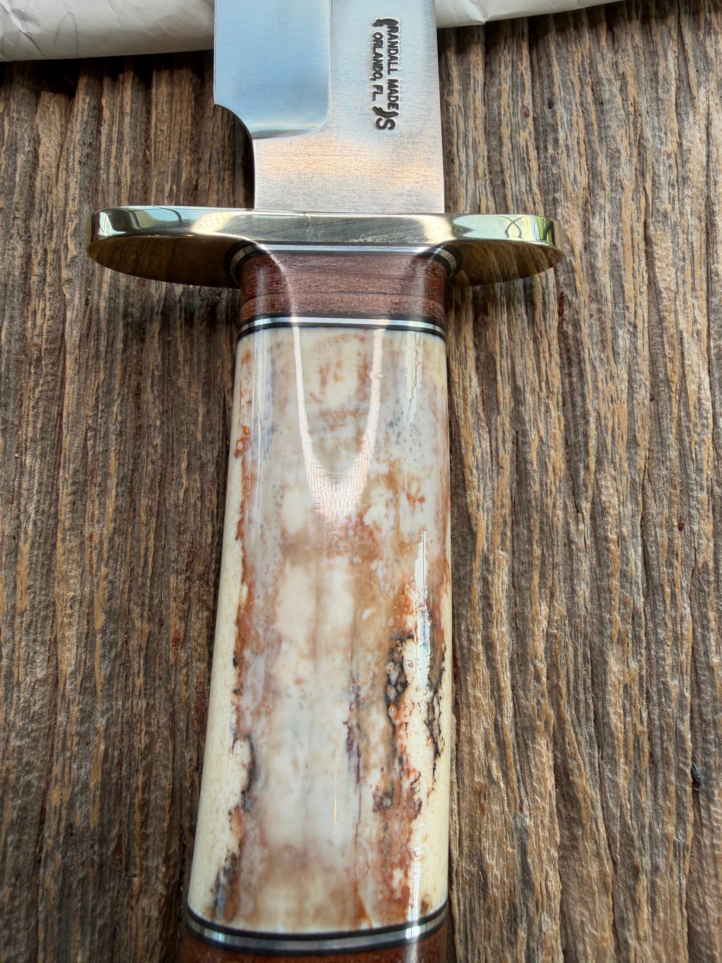 New in Paper Randall Model 12-9 Fossil Walrus Ivory and 25 style stacked Leather grip. Double Nickel Silver hilt and nickel butt cap.