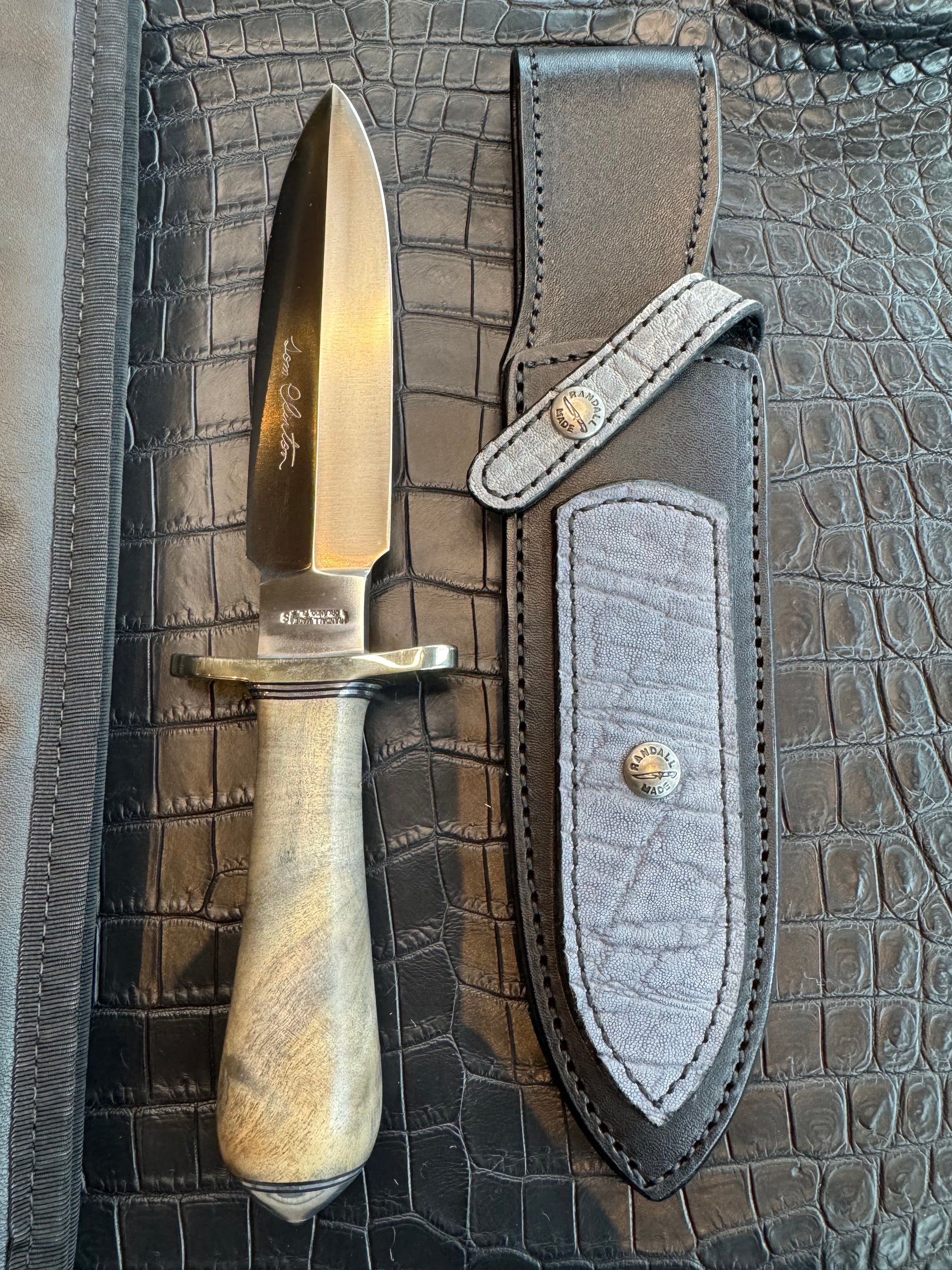 Randall Tom Clinton Dealer Special. Clinton Blade etched Commemorative 1/100 in a nice piece of Walnut. Very cool matching Elephant Gutcher sheath. Nickel Silver Hilt and Aluminum Coolie Butt cap. Included in black facsimile Tom Clinton case.