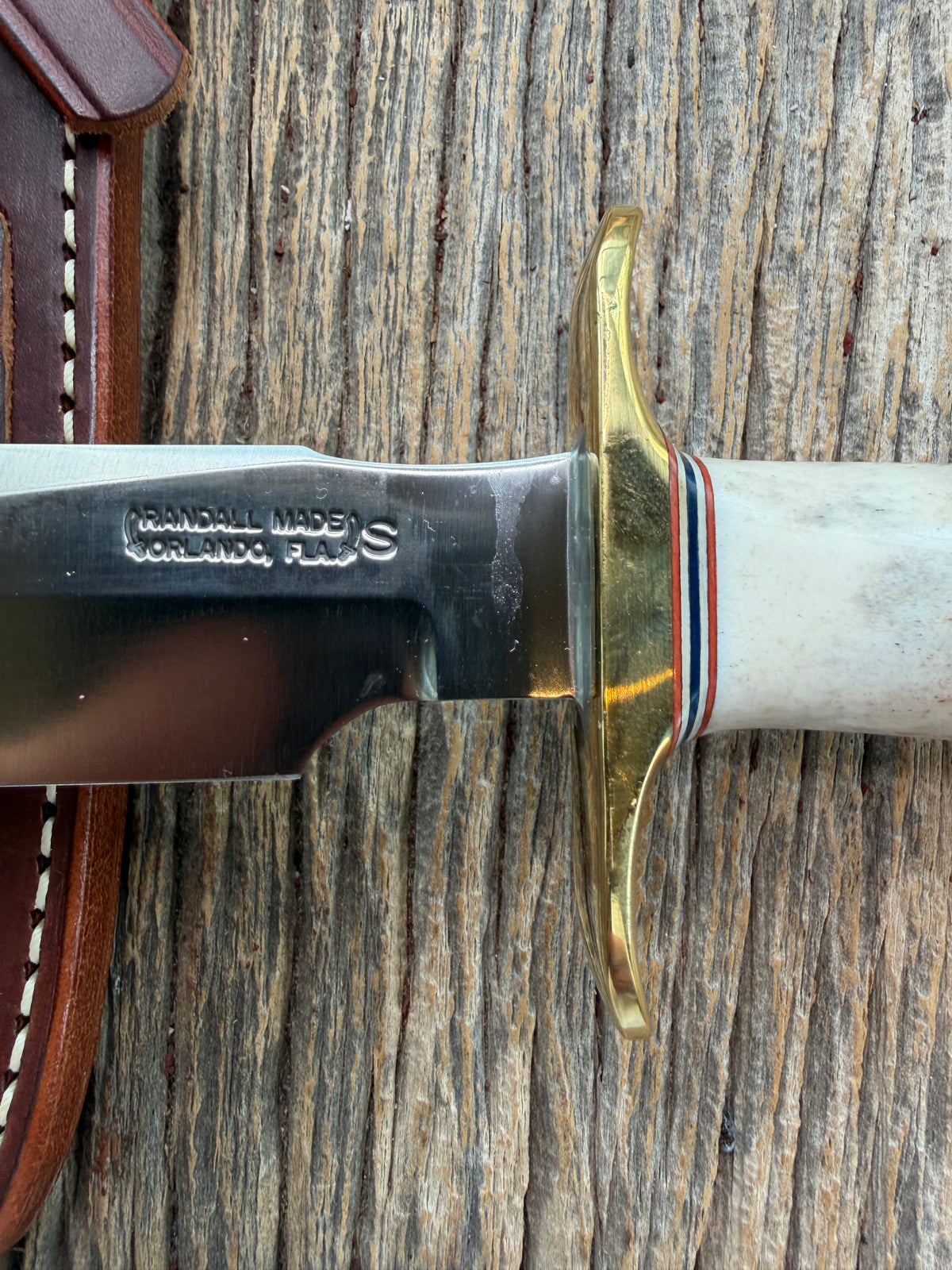 New Randall Model 1-6 with a Stag handle. Stainless steel blade, brass hilt and natural butt. Red white and Blue spacers.