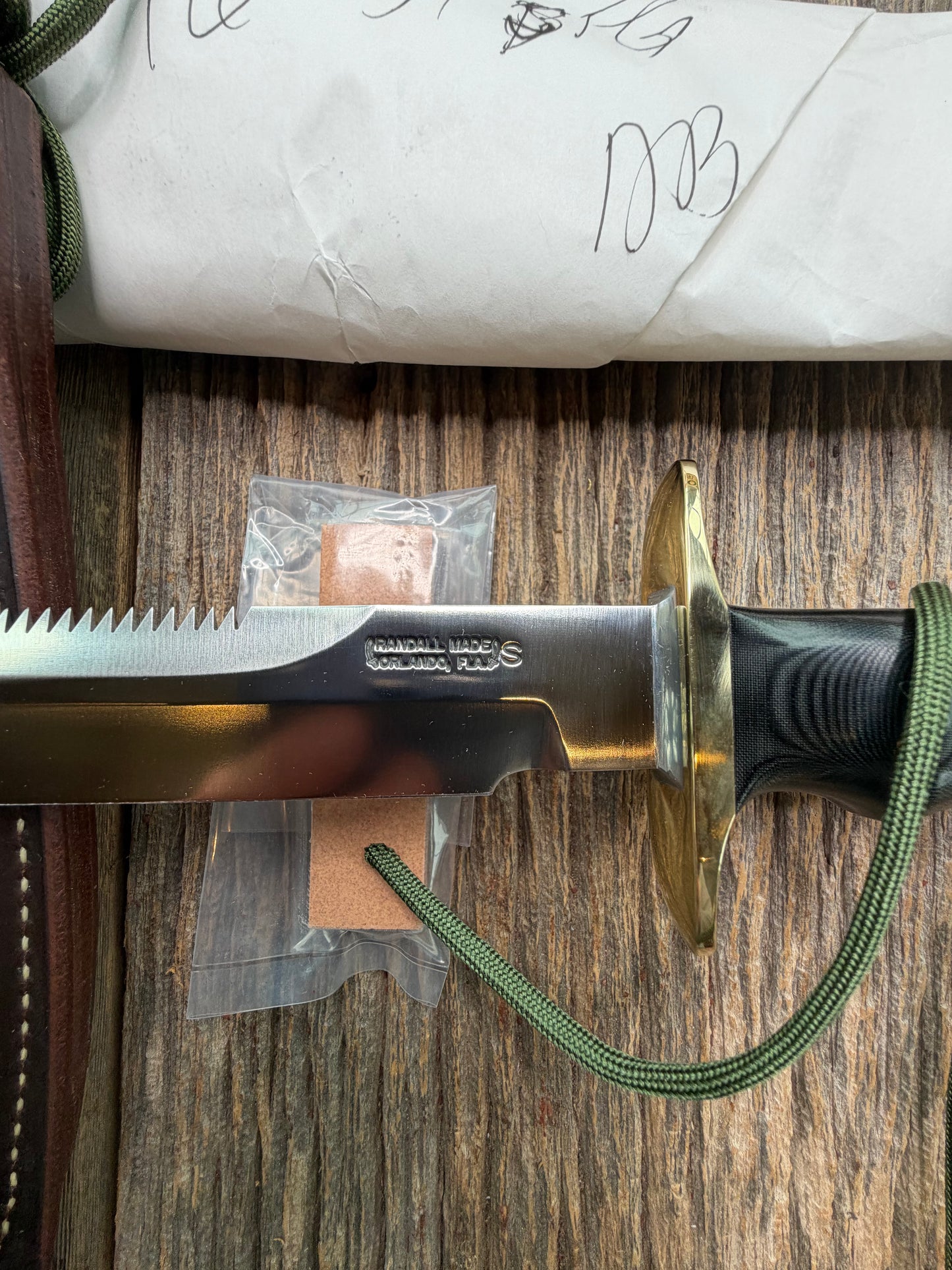 New in Paper Randall Model 16-7 Diver with a Black Micarta handle, Single finger grip , SS blade, Brass hilt, Sawteeth, Lanyard, Brown leather waxed sheath.