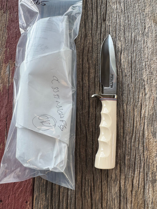 Randall Model Combat Companion with a nice piece of customer supplied Warthers Resin with finger grooves. Teeth, Stainless Steel, Nickel Silver Hilt and a raw natural end.