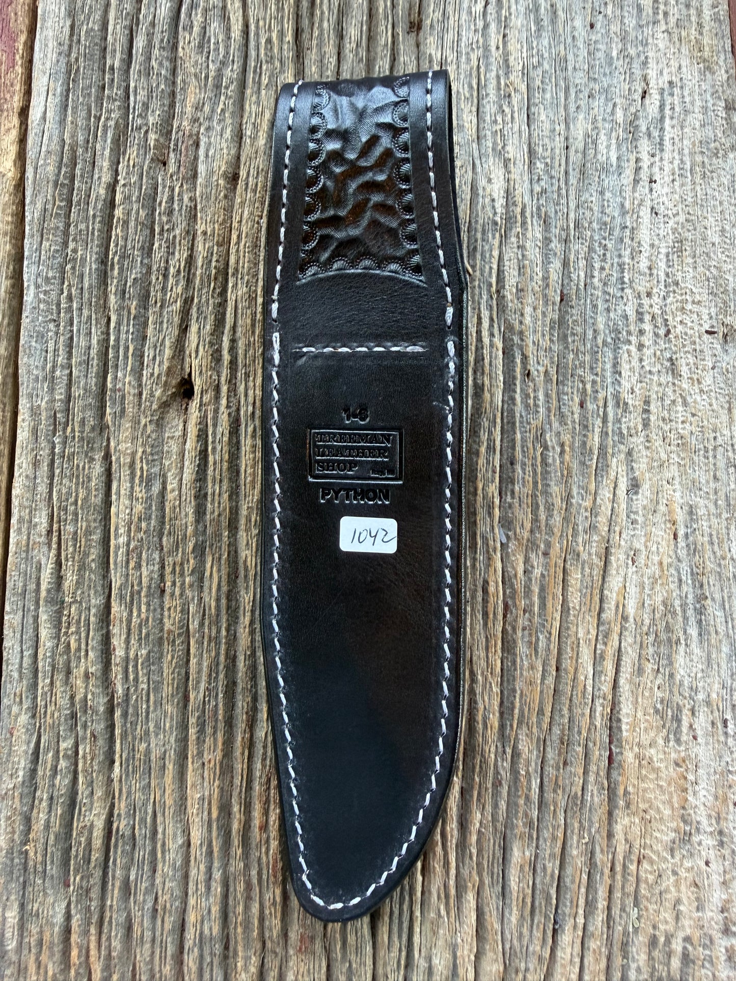 New Randall Model 1-6 Sheath in Exotic Brown Python Snake skin on black leather from Treeman with a black Canteen snap. Hand tooled belt loop. Deviated white stitching. Killer sheath.