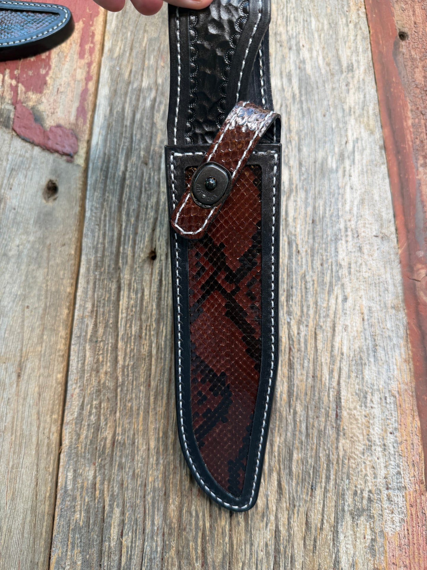 New Randall Model 1-8 Sheath in Exotic Brown Python Snake skin on black leather from Treeman with a black Canteen snap. Hand tooled belt loop. Deviated white stitching. Killer sheath.