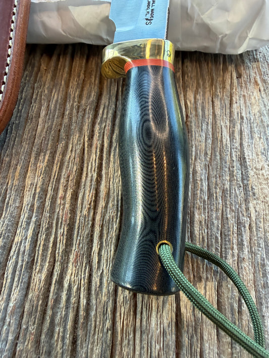 New in Paper Randall Chef’s Knife. Black Micarta in Brass with red spacers. Natural end, stainless steel blade and a lanyard.