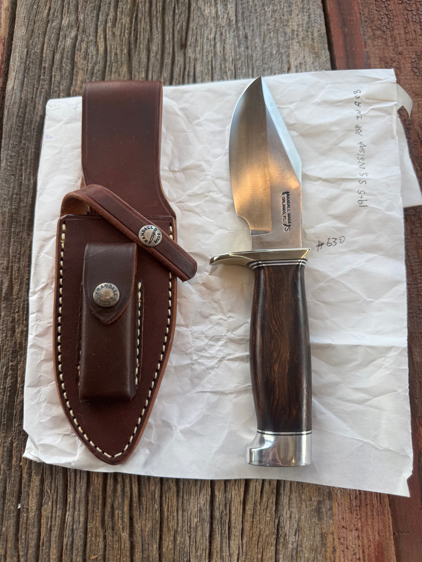 New in Paper Randall Model 19-5 Bushmaster with an Ironwood handle. SS blade, Nickel silver single hilt. Brown leather sheath.