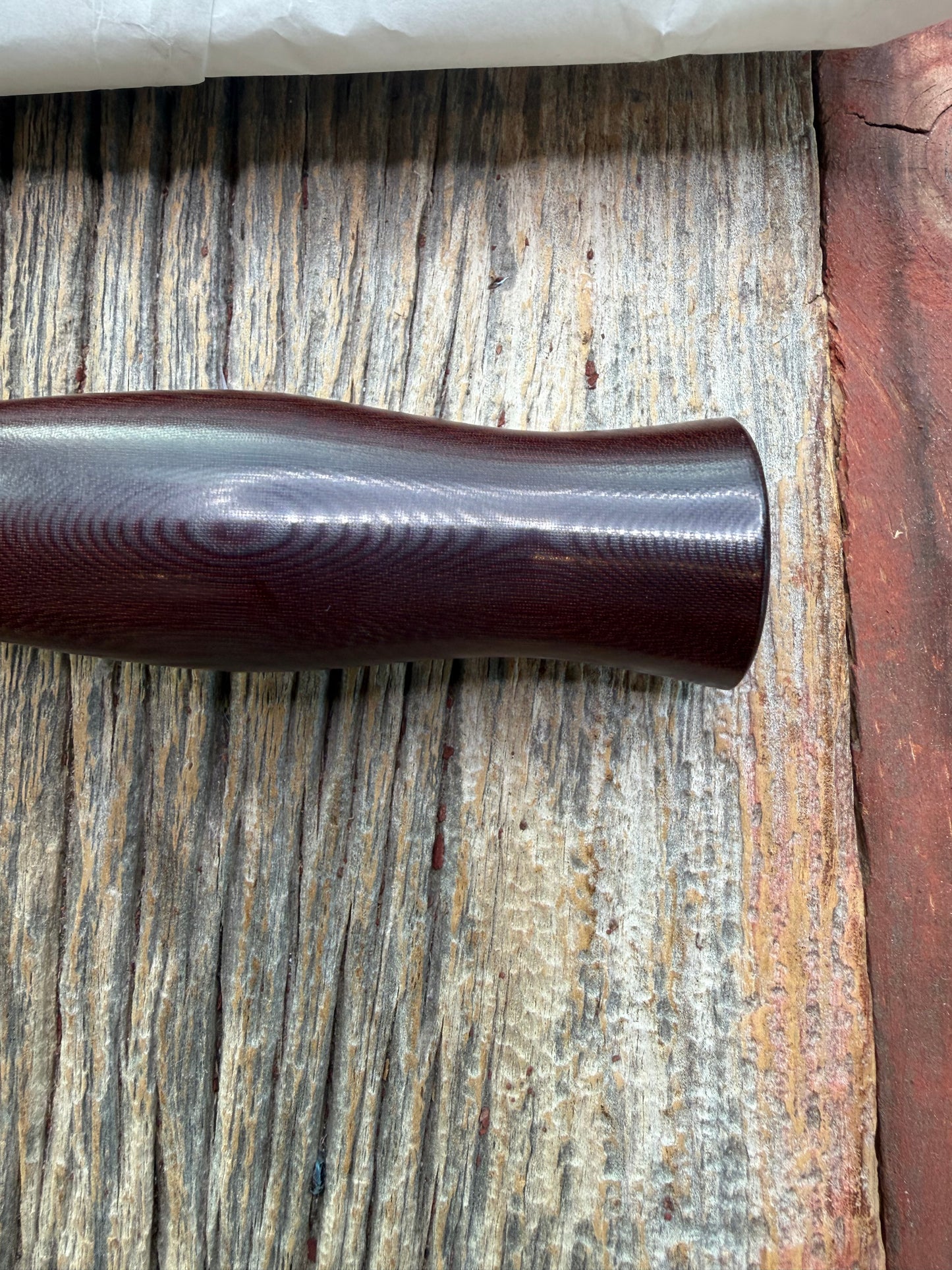 New in Paper Randall Model 12-6 Little Bear with a Maroon Micarta handle. Brass Hilt  and Brass collar Carbon steel, natural end.