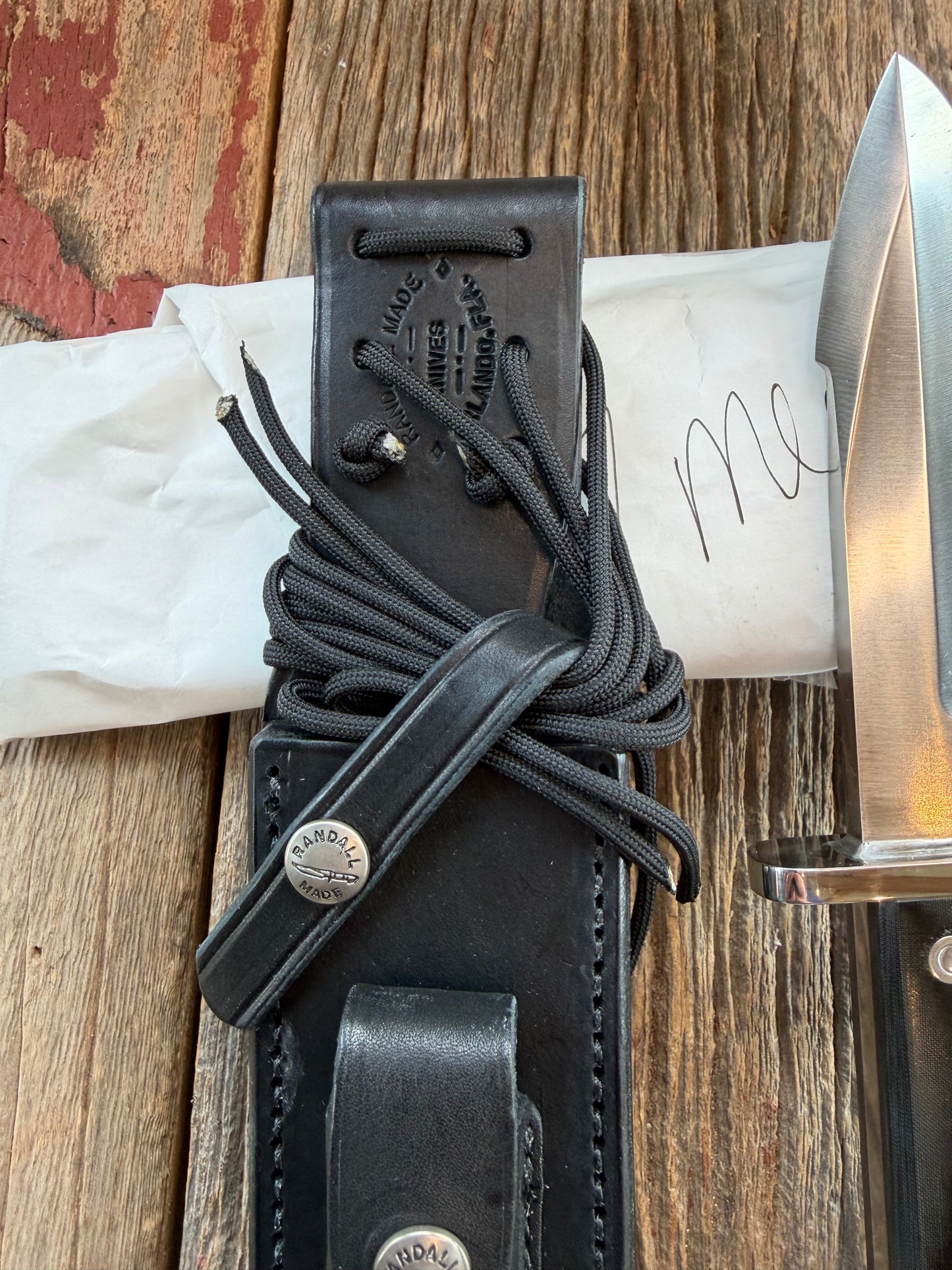 New in Paper Randall Model 17-5.5 Astro knife is a custom, handmade combat knife with a 5.5" stainless steel clip point blade and a brown leather sheath. Full tang design, black handle.