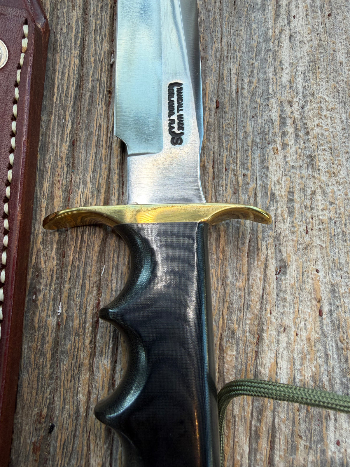 New in paper Randall Model 16 SP#1 Special fighter with a Black Micarta handle. SS blade, brass hilt. Lanyard. Brown leather sheath.