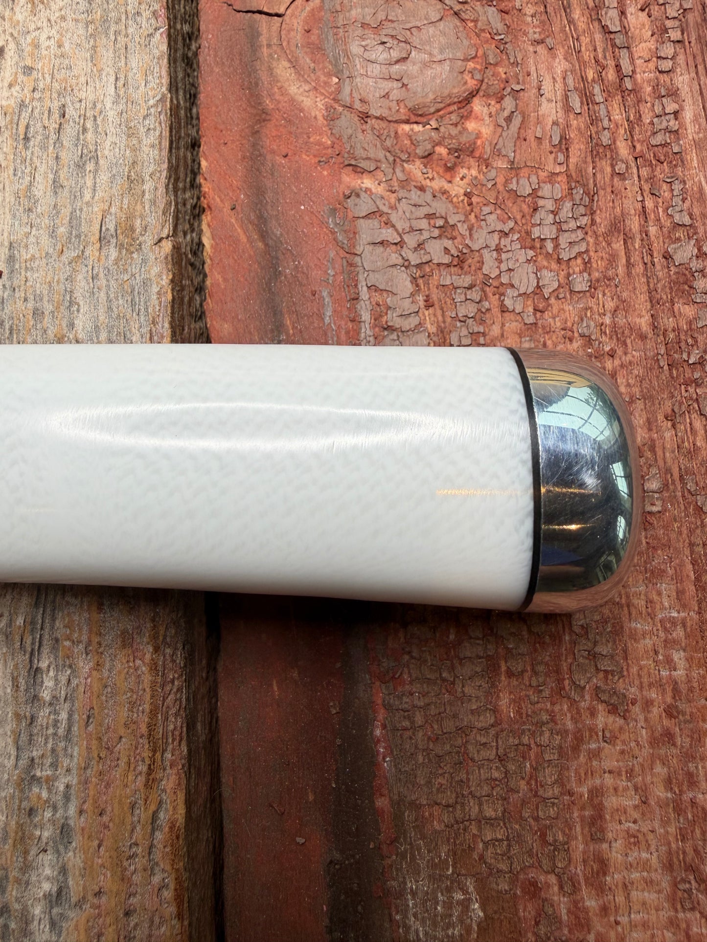 Randall Model 14-7.5 with a White Ivorite handle. Stainless steel blade, Nickel silver hilt and collar. Upgraded Black leather sheath.  Roundsd Aluminum butt cap.