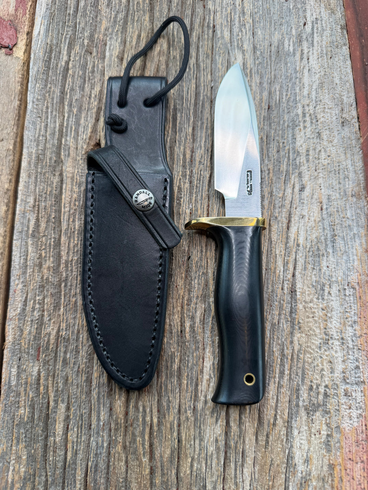 Nice Randall Model 28 Woodsman in Black Micarta. SS blade, brass single hilt. Lanyard hole. Black leather sheath.