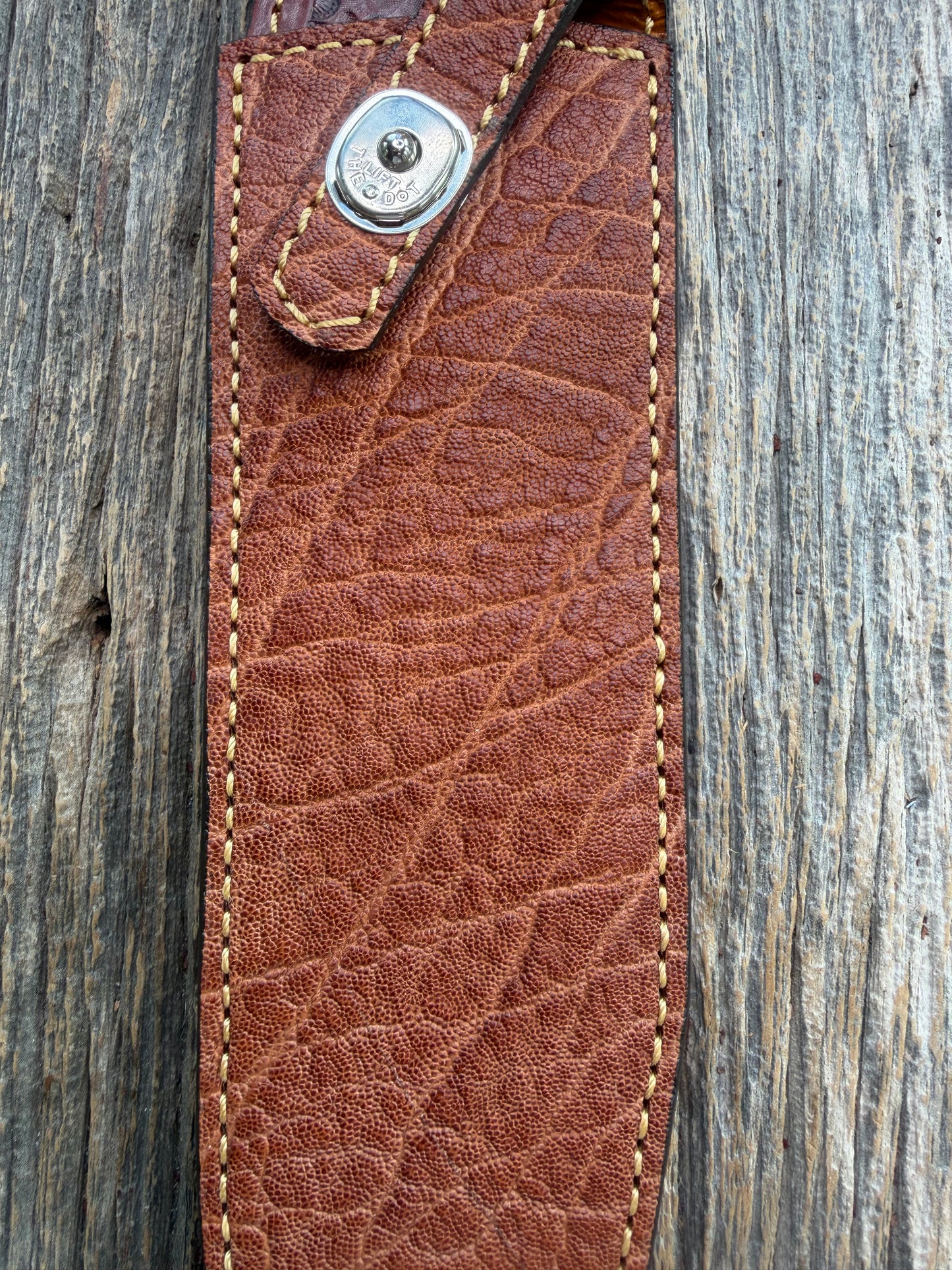 New Randall Model 12-9/14 Sheath in Exotic thick and textured Rust colored Elephant hide on brown leather from Treeman with a silver Canteen snap. Hand tooled belt loop. Killer sheath.