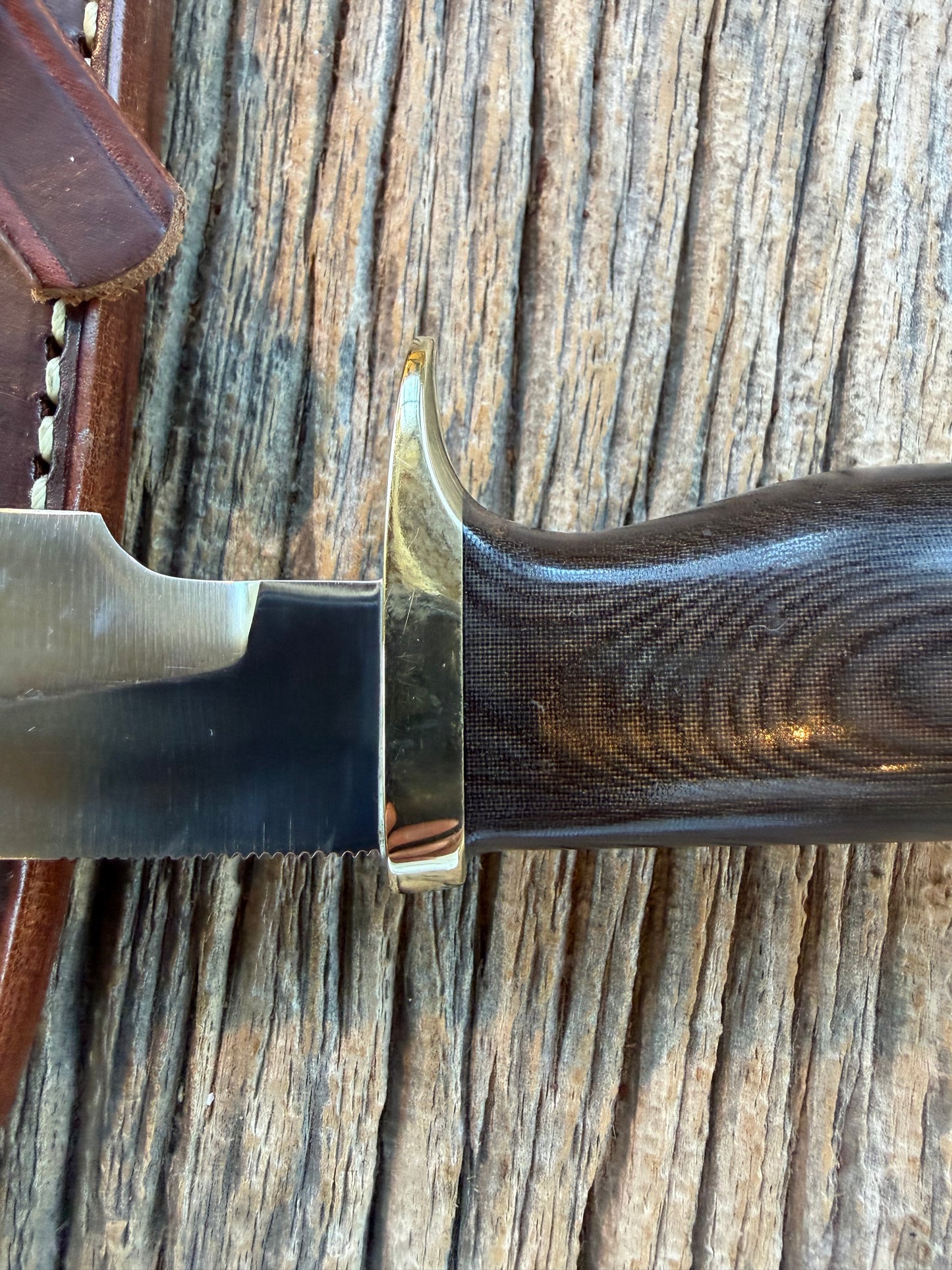 Nice Randall Model 28 Woodsman in Black Micarta. SS blade, brass single hilt. Lanyard. Brown leather sheath.