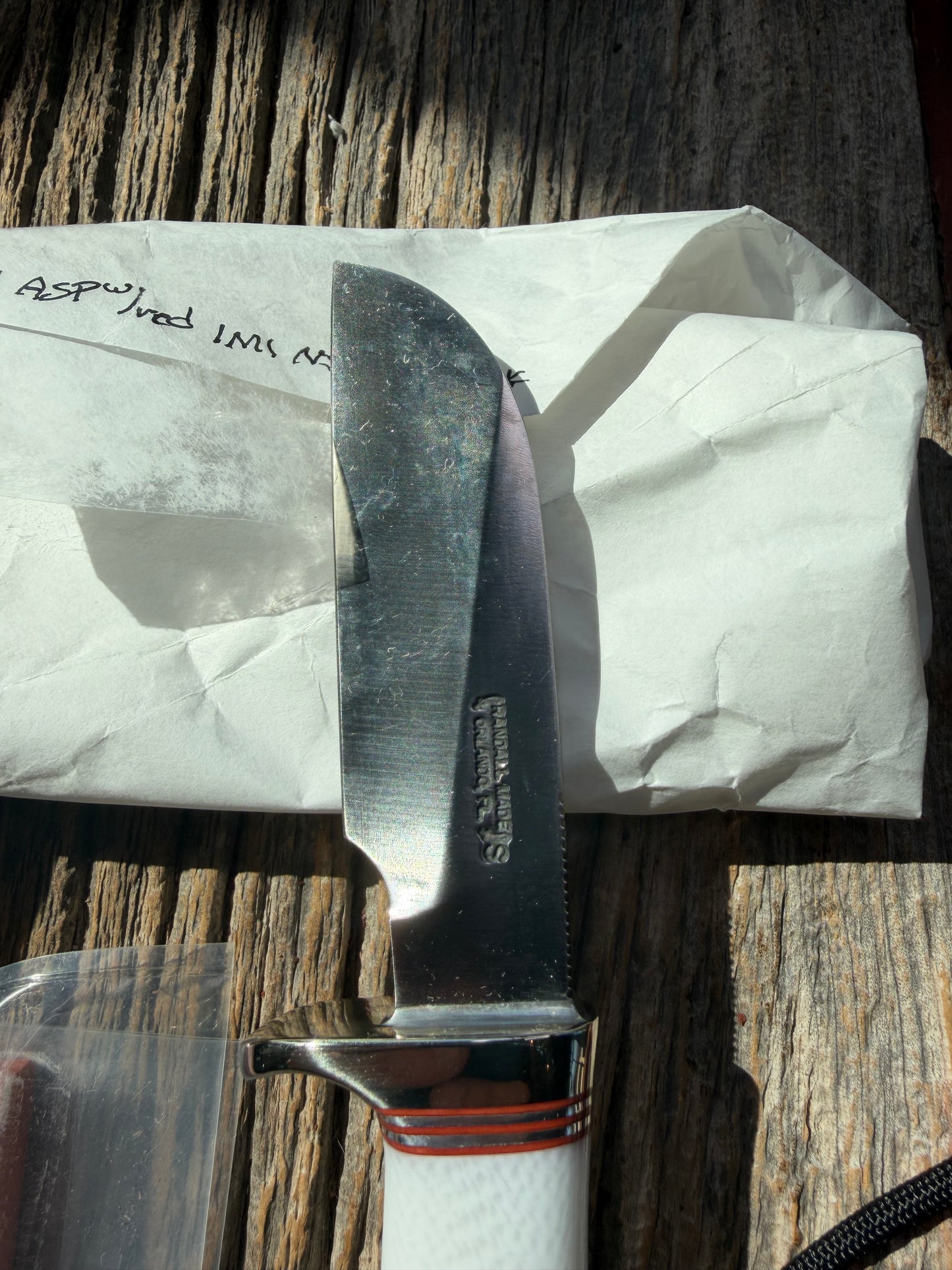 New in Paper Randall Non Catalog Model  Cattleman. White Ivorite handle. Red and silver spacers. Stainless blade.