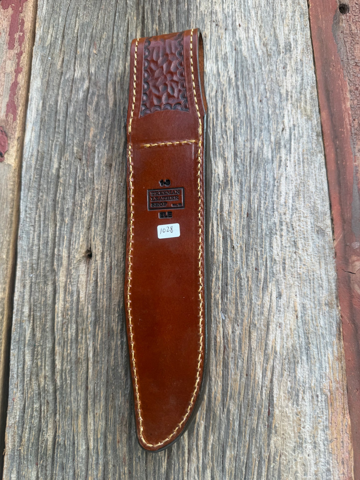 New Randall Model 1-8 Sheath in Exotic thick and textured Rust colored Elephant hide on brown leather from Treeman with a silver Canteen snap. Hand tooled belt loop. Killer sheath.