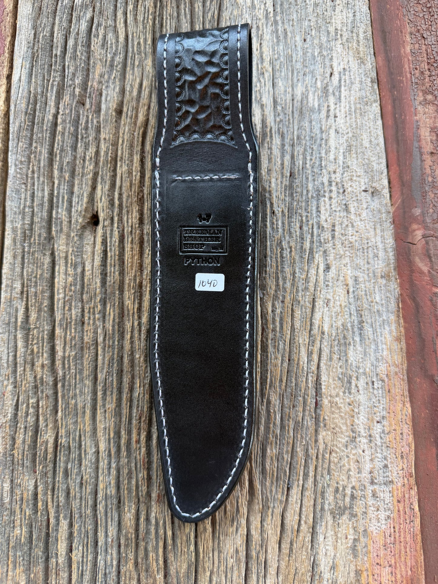 New Randall Model 1-7 Sheath in Exotic Brown Python Snake skin on black leather from Treeman with a black Canteen snap. Hand tooled belt loop. Deviated white stitching. Killer sheath.