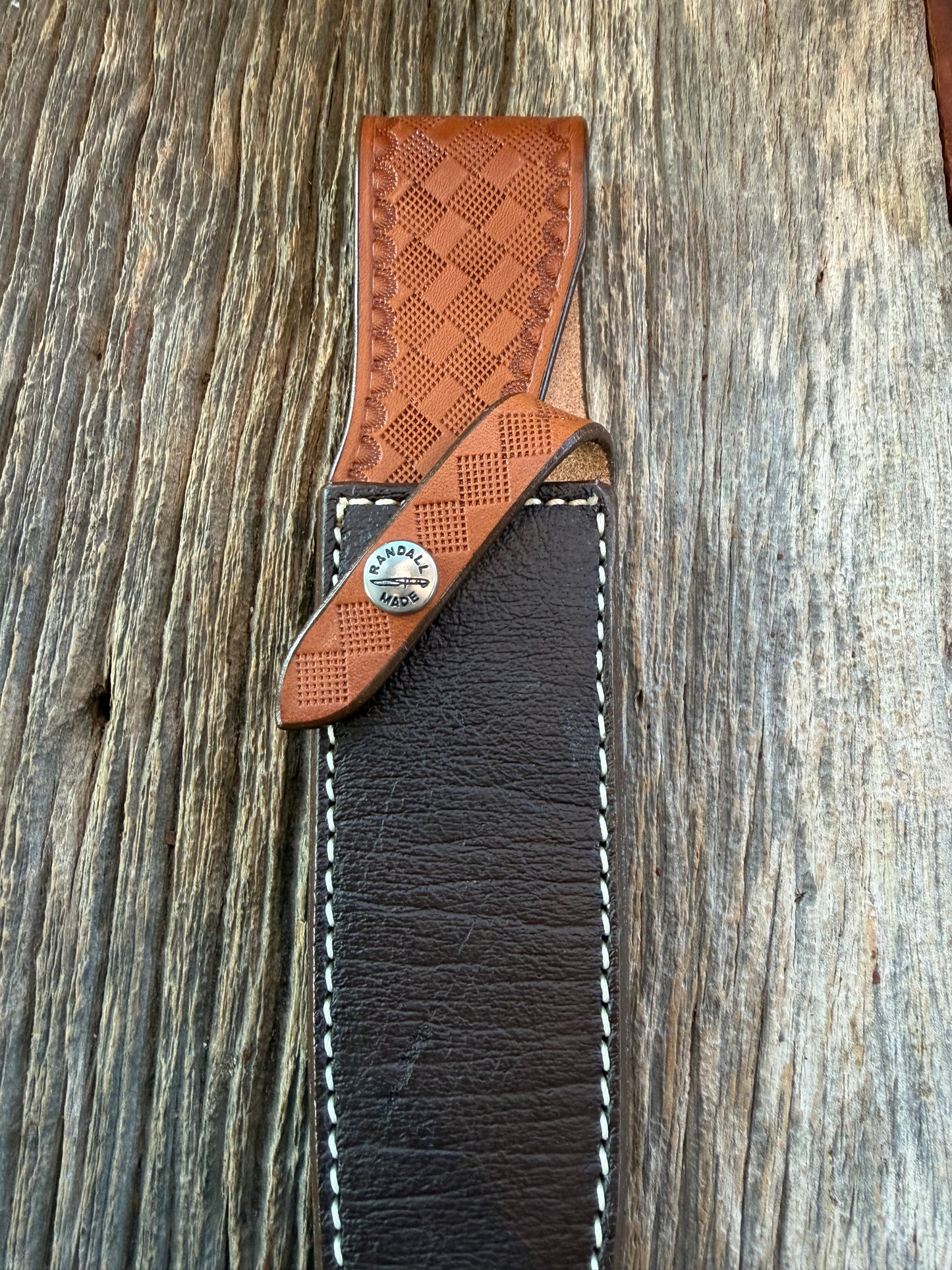 New Randall Model 2-7 Sheath in Exotic Brown Cape Buffalo with full leather hand tooled belt loop. Randall snap and stamp on the back. Custom Made at Sullivan’s by Gutcher