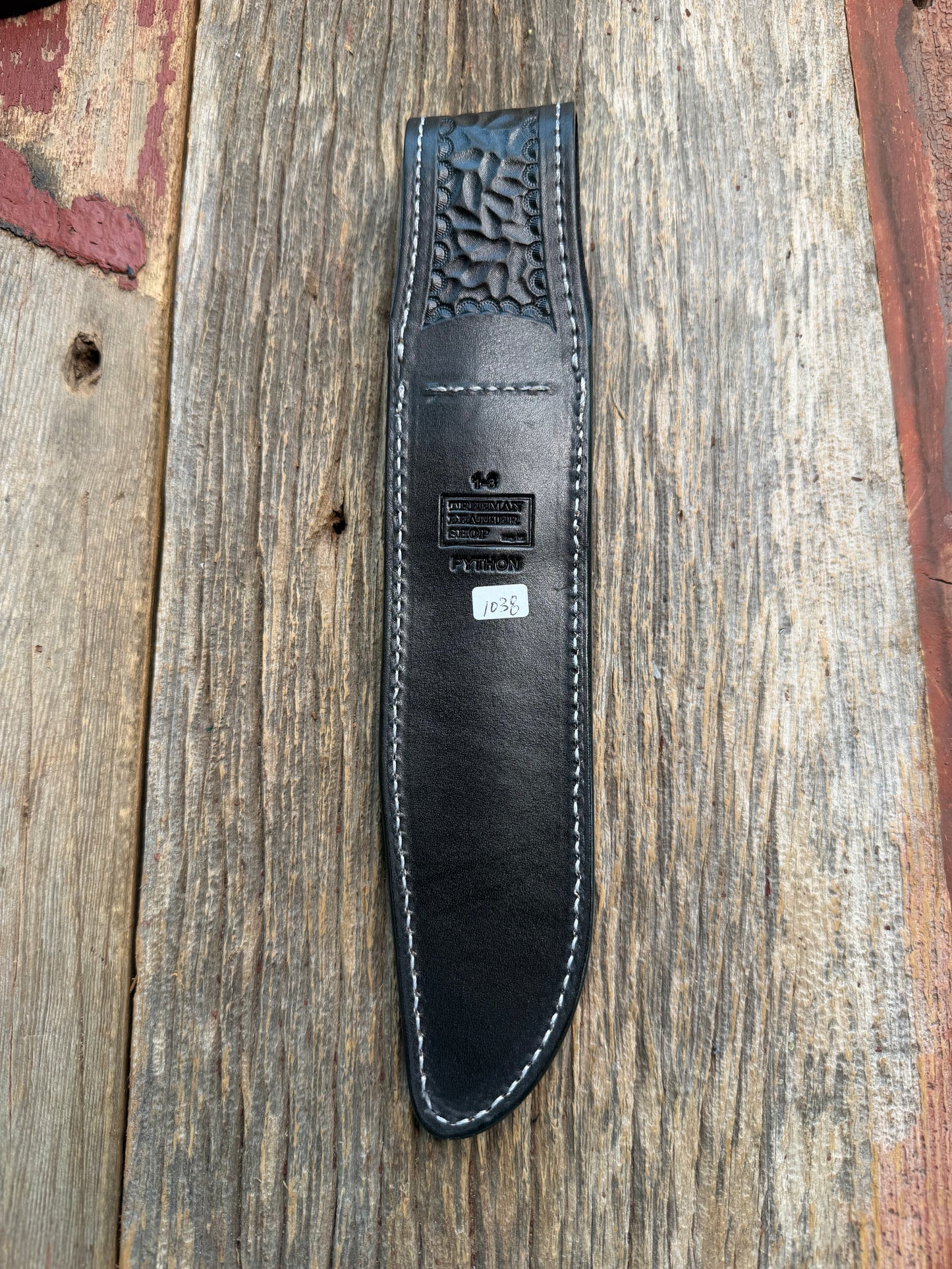New Randall Model 1-8 Sheath in Exotic Brown Python Snake skin on black leather from Treeman with a black Canteen snap. Hand tooled belt loop. Deviated white stitching. Killer sheath.