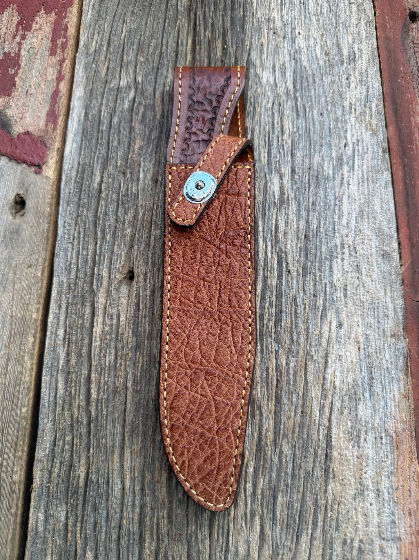 New Randall Model 1-8 Sheath in Exotic thick and textured Rust colored Elephant hide on brown leather from Treeman with a silver Canteen snap. Hand tooled belt loop. Killer sheath.