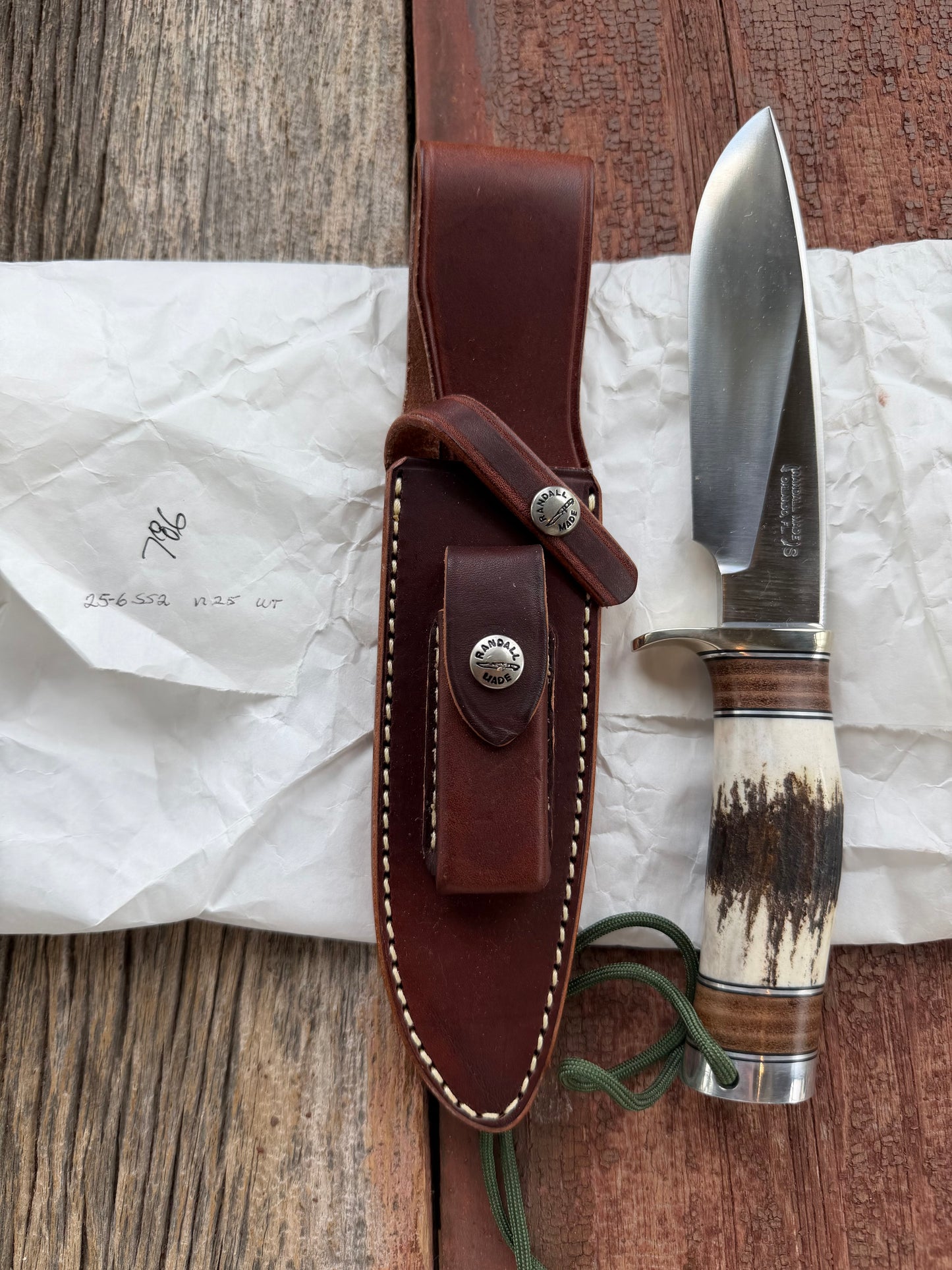 New in paper Randall Knife Model 25-6 Trapper in Stag Leather Handle Stainless Blade, nickel silver hilt , wrist thong.