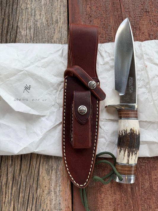 New in paper Randall Knife Model 25-6 Trapper in Stag Leather Handle Stainless Blade, nickel silver hilt , wrist thong.