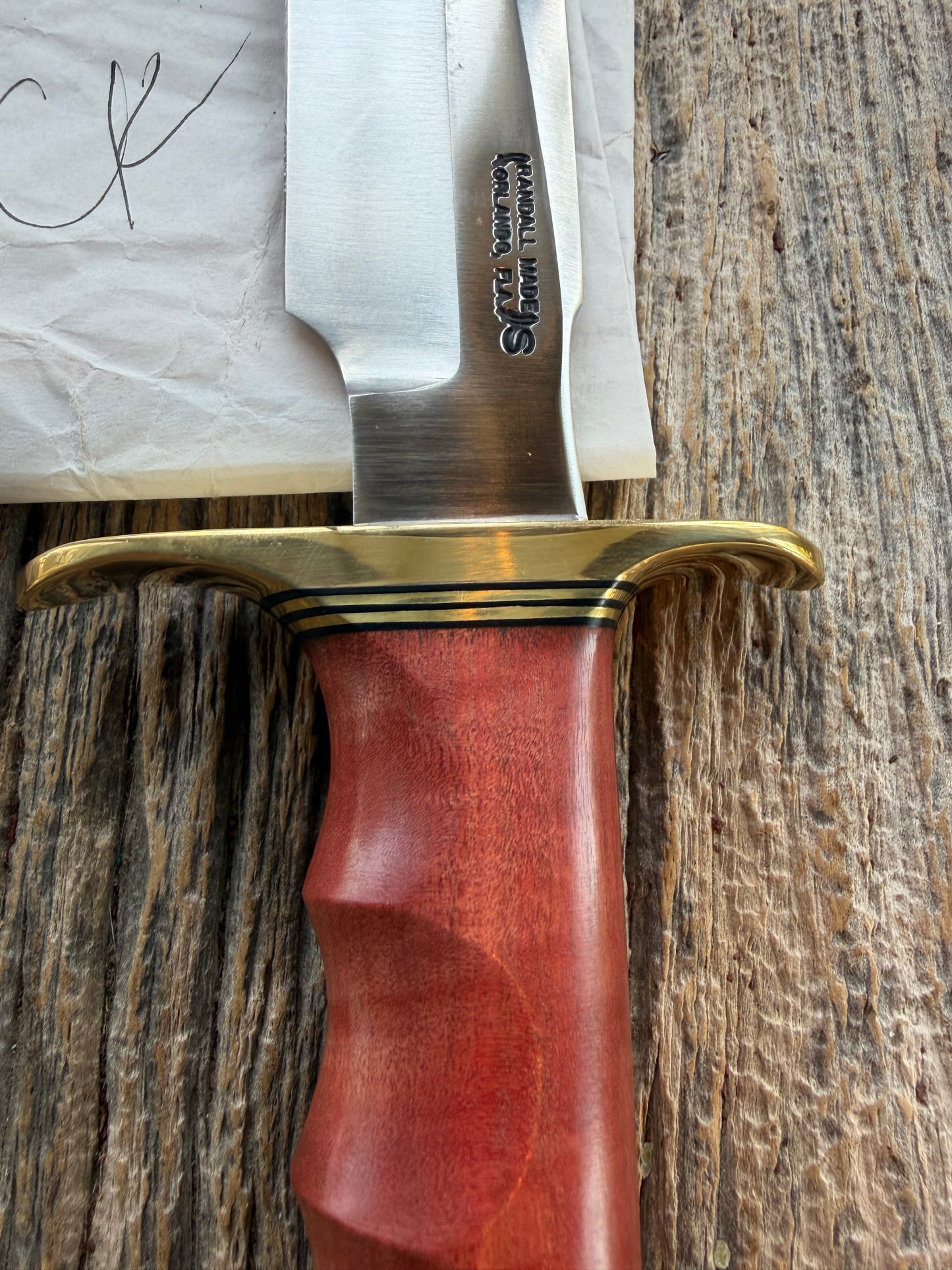 New in Paper Randall Made Knife Model 1-8 in Pink Ivory wood. Stainless steel, Black and Gold spacers, Brass Hilt and butt cap.
