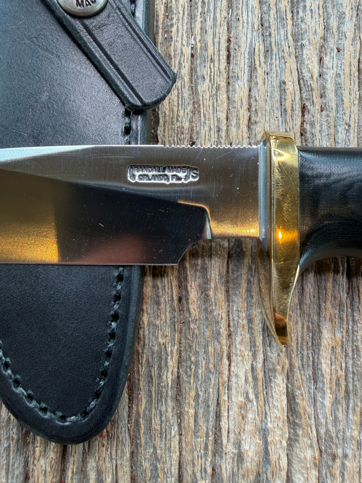 Nice Randall Model 28 Woodsman in Black Micarta. SS blade, brass single hilt. Lanyard hole. Black leather sheath.