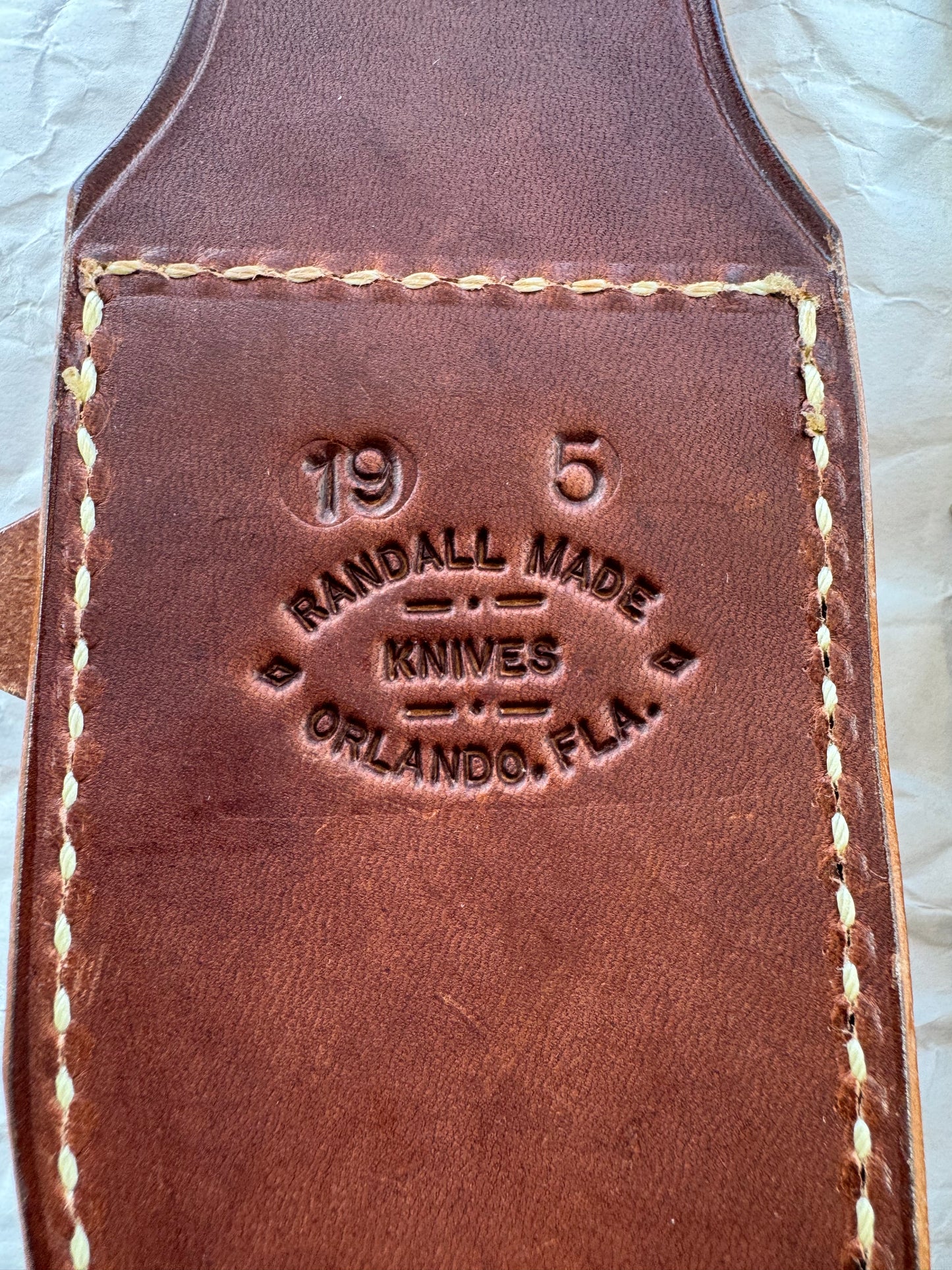 New in Paper Randall Model 19-5 Bushmaster with an Ironwood handle. SS blade, Nickel silver single hilt. Brown leather sheath.