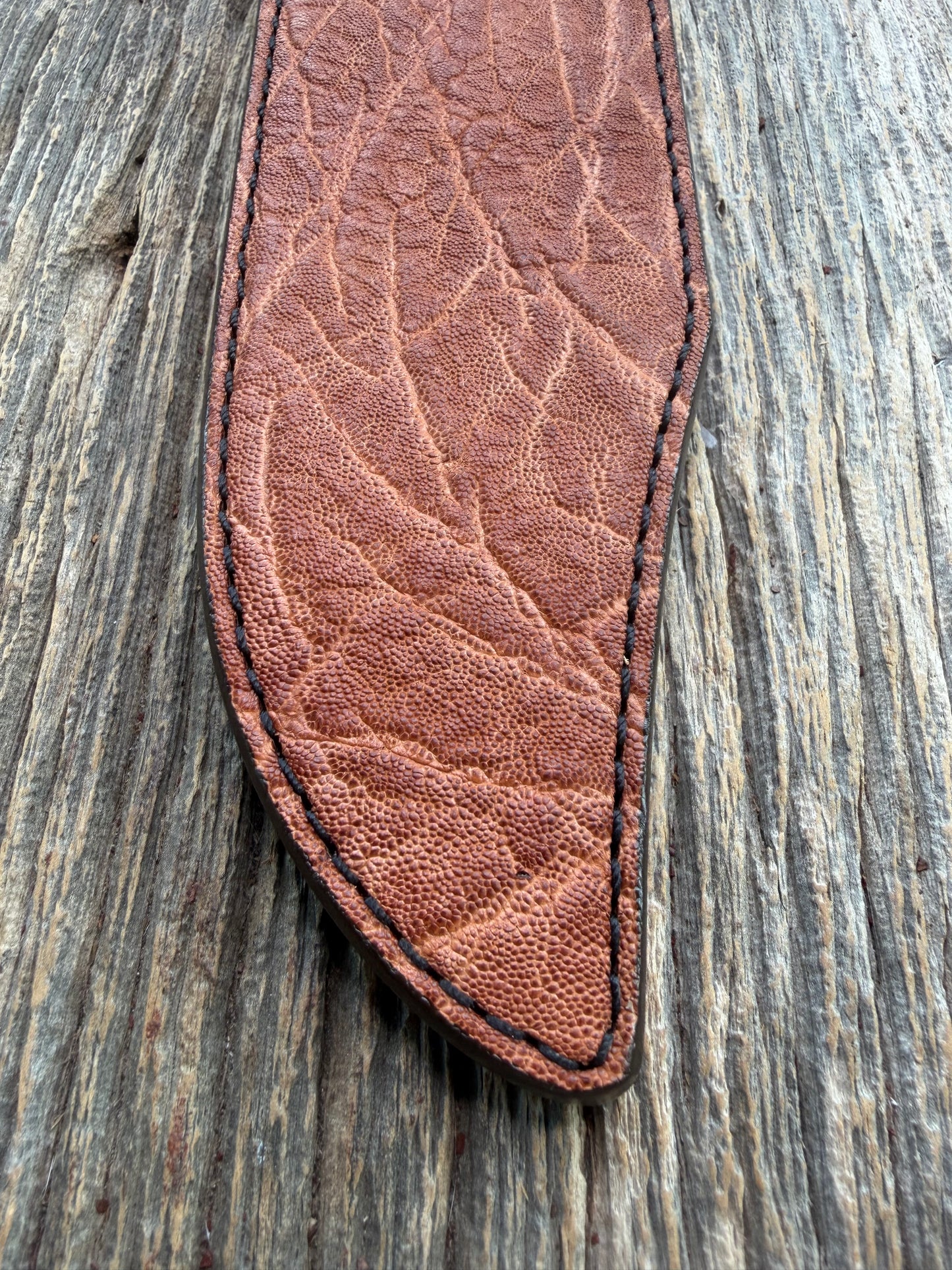 New Randall Model 12-9/14 Sheath in Exotic thick and textured Rust colored Elephant hide on brown leather from Treeman with a black Canteen snap. Hand tooled belt loop. Killer sheath.