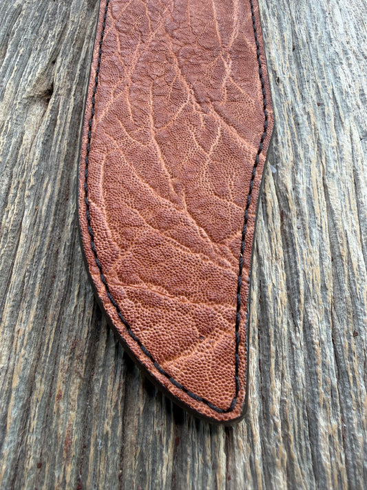 New Randall Model 12-9/14 Sheath in Exotic thick and textured Rust colored Elephant hide on brown leather from Treeman with a black Canteen snap. Hand tooled belt loop. Killer sheath.