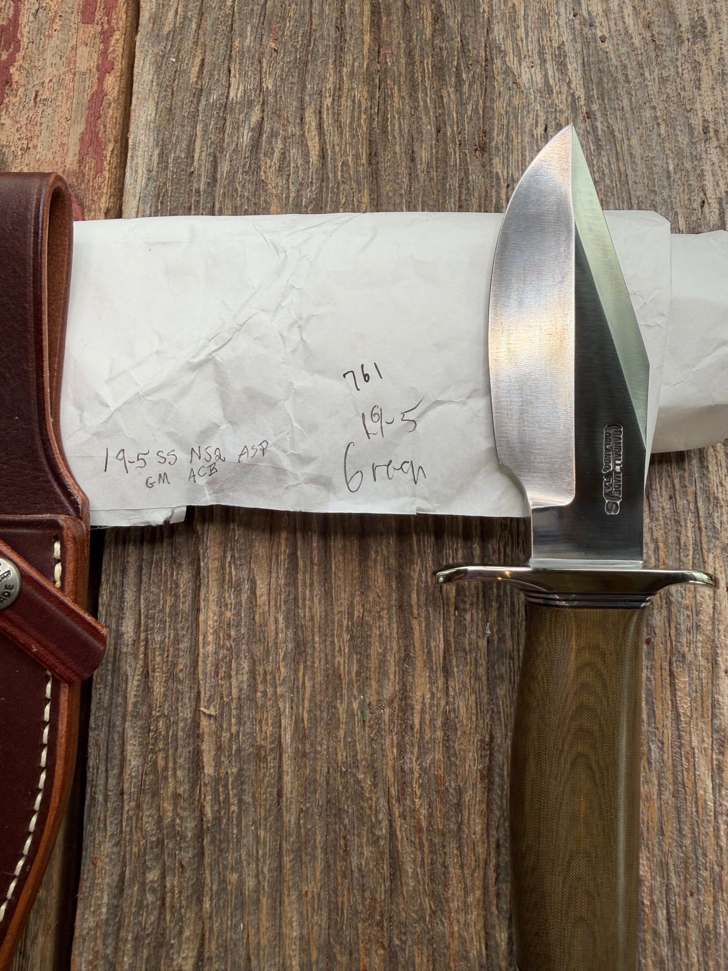 New in Paper Randall Model 19-5 Bushmaster with a Green Micarta handle. Stainless steel blade, Nickel silver hilt. Brown leather sheath. Crows Beak Aluminum handle.