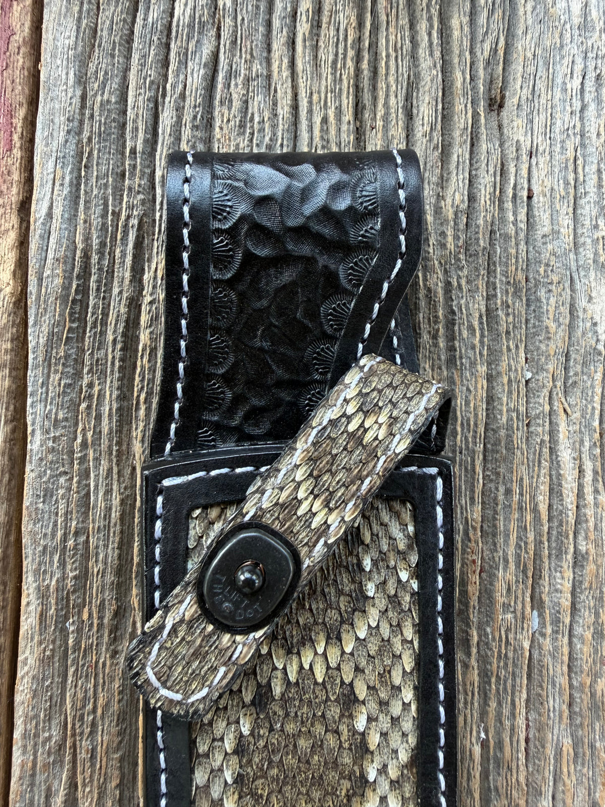 Randall Model Clinton Special sheath with inlayed Western Diamondback RattleSnake skin from Treeman Sheaths. Very dark skin on brown leather, white deviated stitching and black canteen snaps.