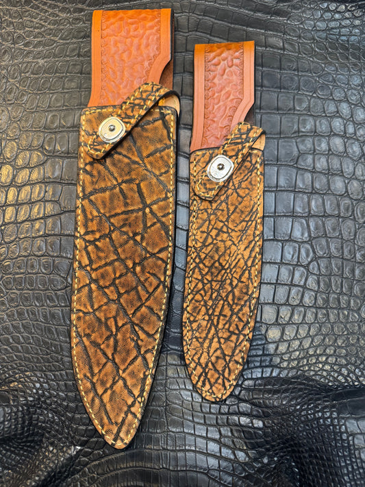 A pair of Randall Model 12-11 Large Sasquatch and Randall Model 12-8 Small Sasquatch Sheaths in Exotic Cognac Elephant by Treeman.