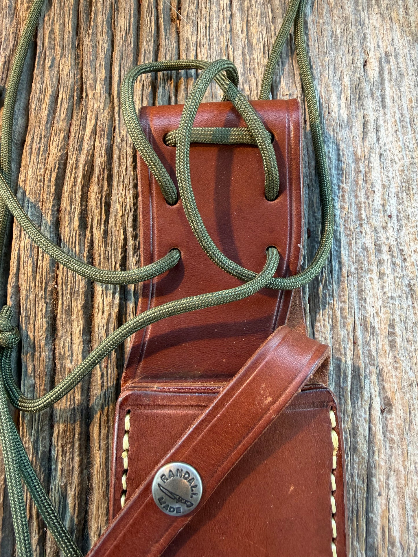Mint Randall by Gutcher Knife Sheath for a Model Buxton Fighter. Randall snaps, double stitched, pouch with stone, lanyards straps as well.