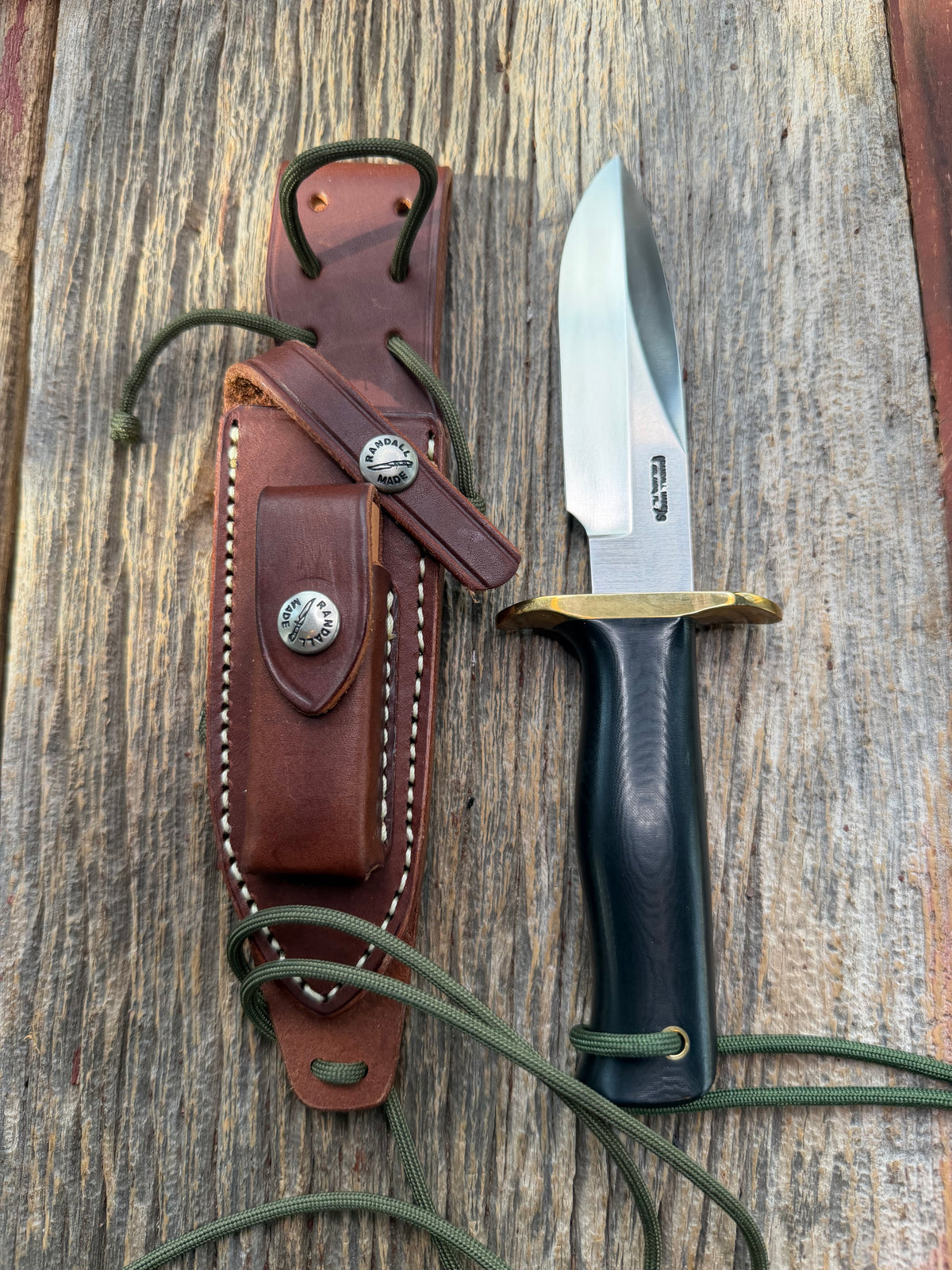 Nice Randall Model Combat Companion in Black Micarta. SS blade, brass hilt. Lanyard and paracord, Brown leather sheath.