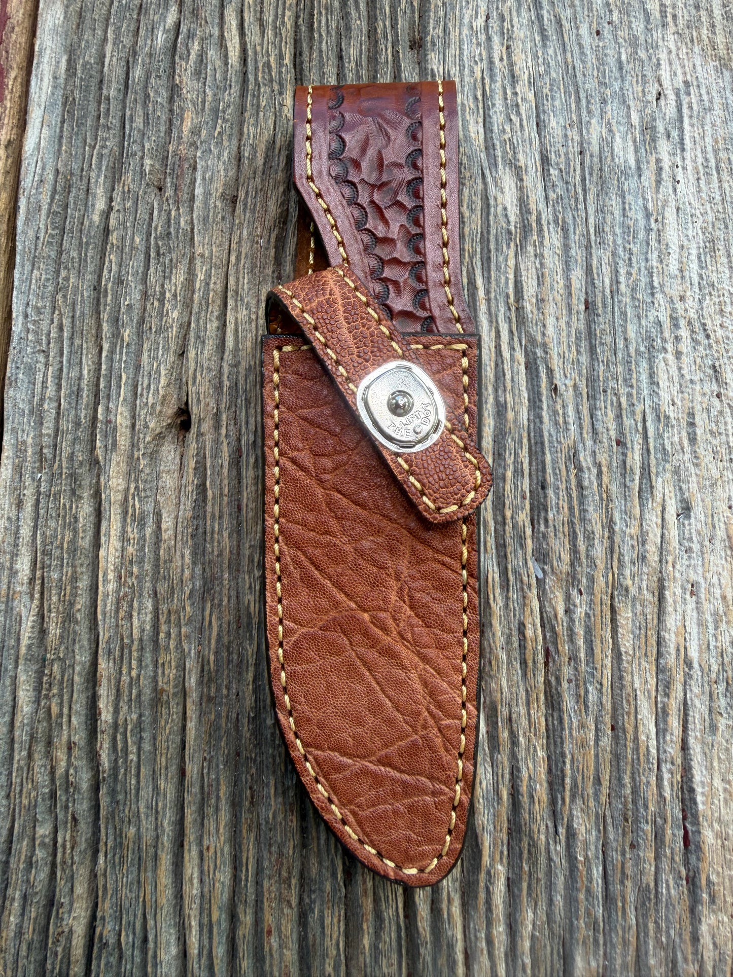 New Randall Model 23 Sheath in Exotic thick and textured Rust colored Elephant hide on brown leather from Treeman with a silver Canteen snap. Hand tooled belt loop. Killer sheath.