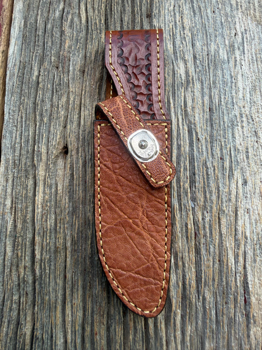 New Randall Model 23 Sheath in Exotic thick and textured Rust colored Elephant hide on brown leather from Treeman with a silver Canteen snap. Hand tooled belt loop. Killer sheath.