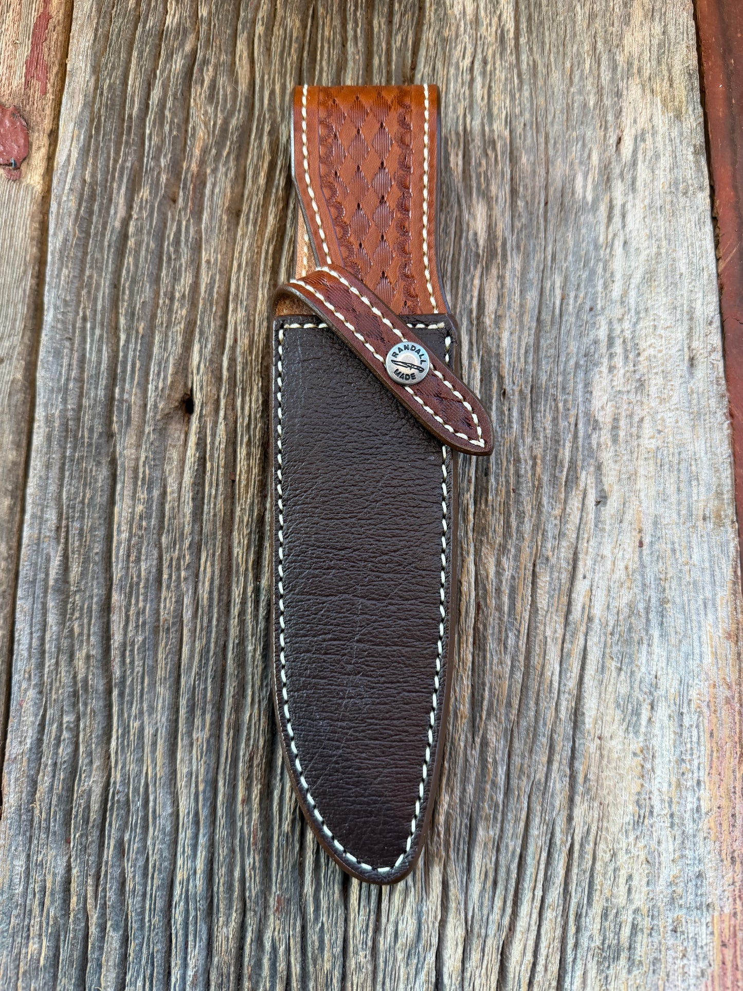 New Randall Model 25-6 Sheath in Exotic Brown Cape Buffalo with full leather hand tooled belt loop. Randall snap and stamp on the back. Custom Made at Sullivan’s by Gutcher