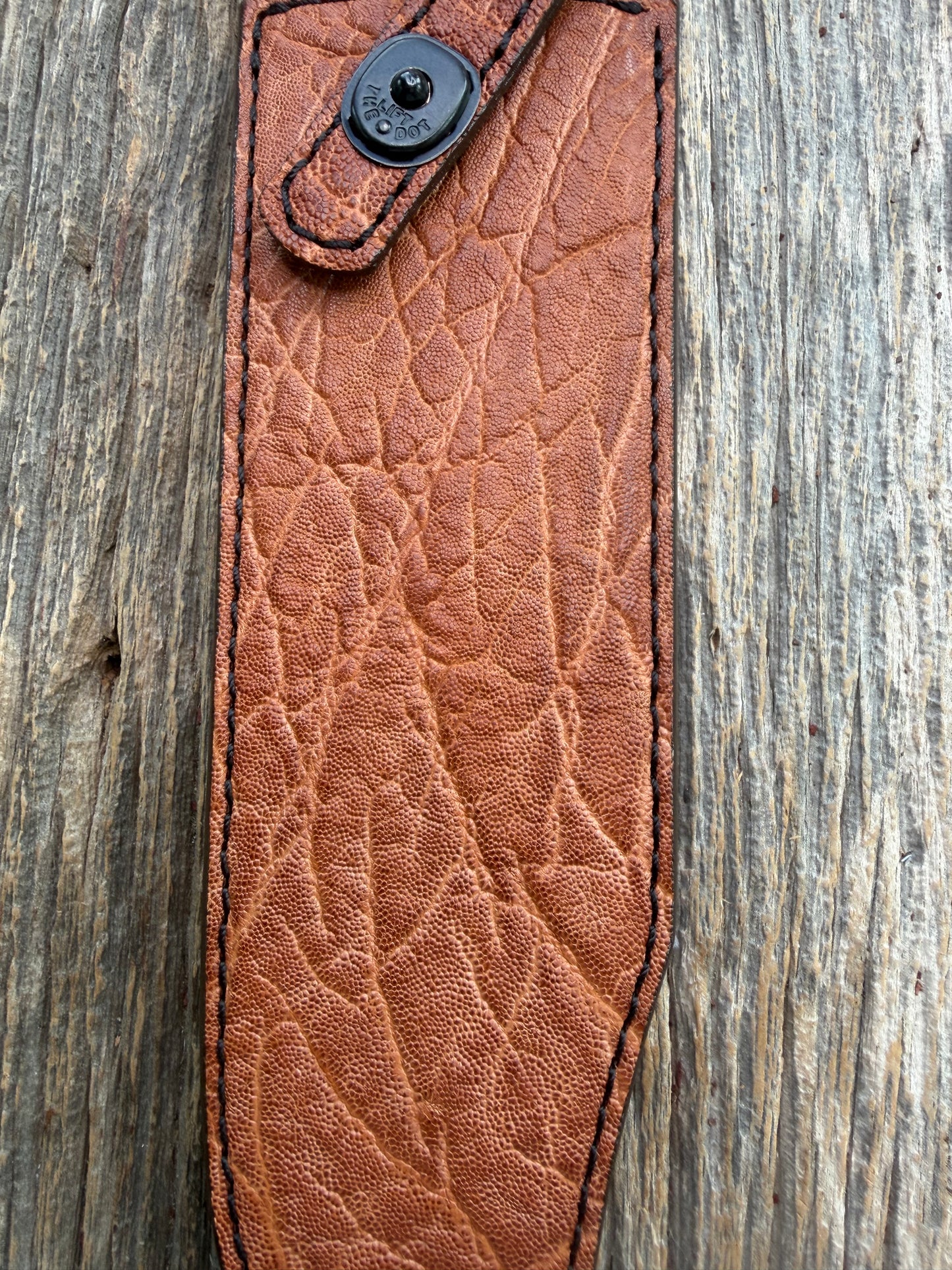New Randall Model 12-9/14 Sheath in Exotic thick and textured Rust colored Elephant hide on brown leather from Treeman with a black Canteen snap. Hand tooled belt loop. Killer sheath.