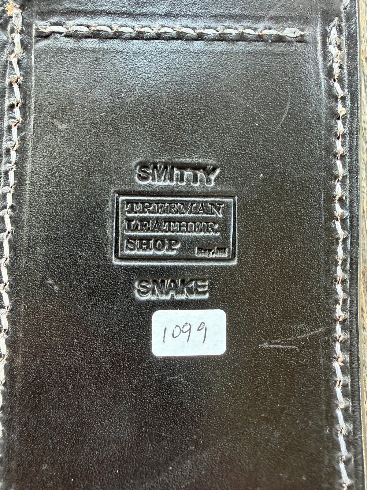 Randall Model Smithsonian sheath with a Western Diamondback RattleSnake skin inlay from Treeman Sheaths. Very dark skin, white thread deviated stitching, black canteen snap.