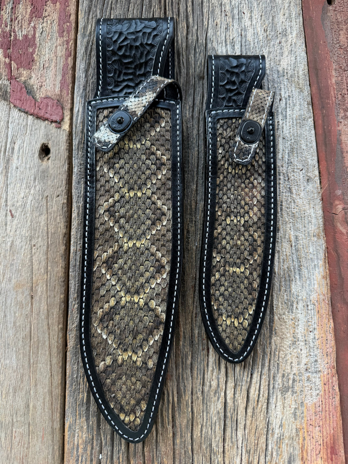 Randall Model Large Sasquatch and Small Sasquatch sheath pair with inlayed Western Diamondback RattleSnake skins from Treeman Sheaths. Very dark skins on brown leather, white deviated stitching and black canteen snaps.