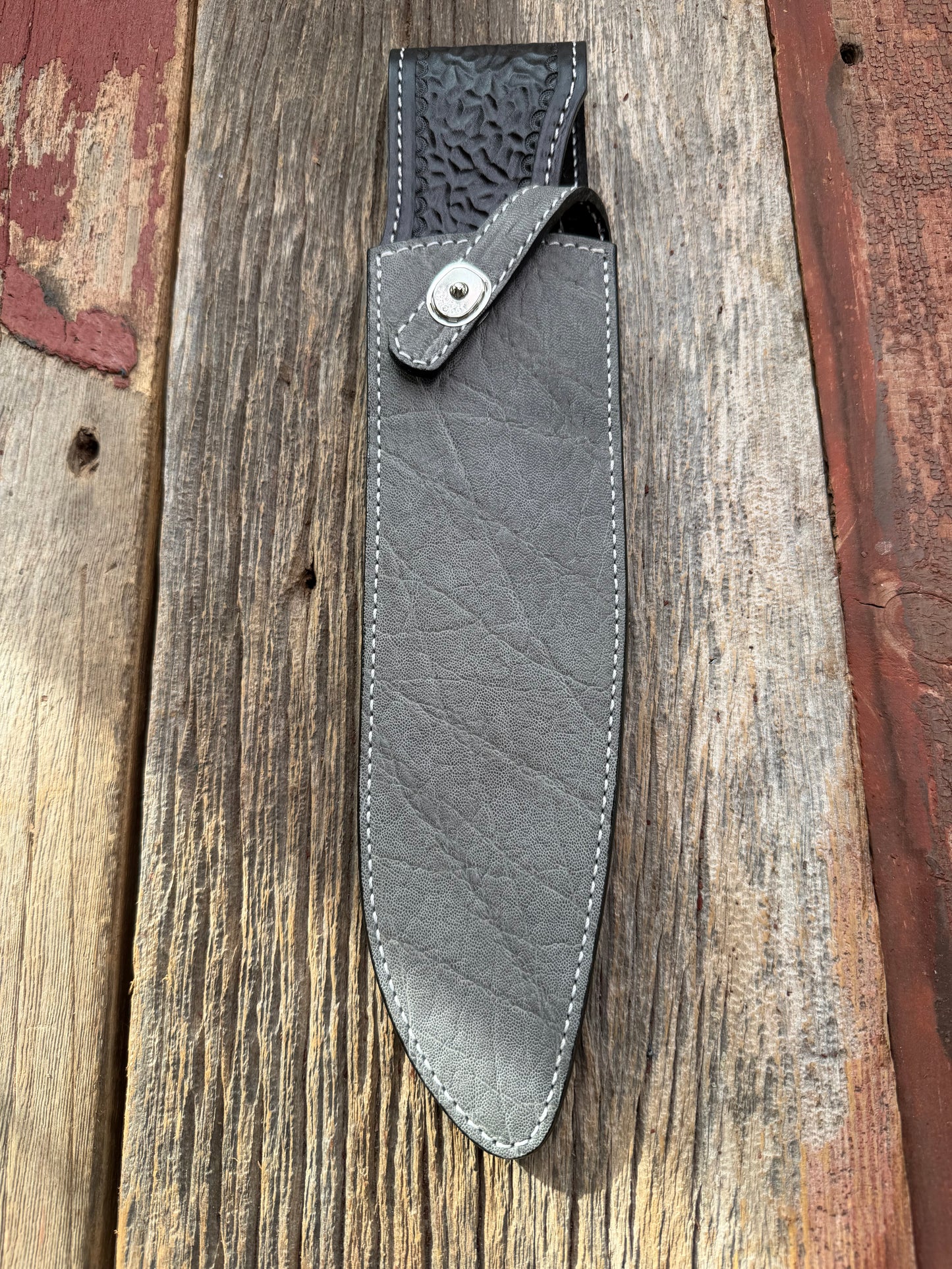 New Randall Model 12-11 Large Sasquatch Sheath in Exotic thick and textured Grey Elephant Hide on black leather from Treeman with a silver Canteen snap. Hand tooled belt loop. Killer sheath.