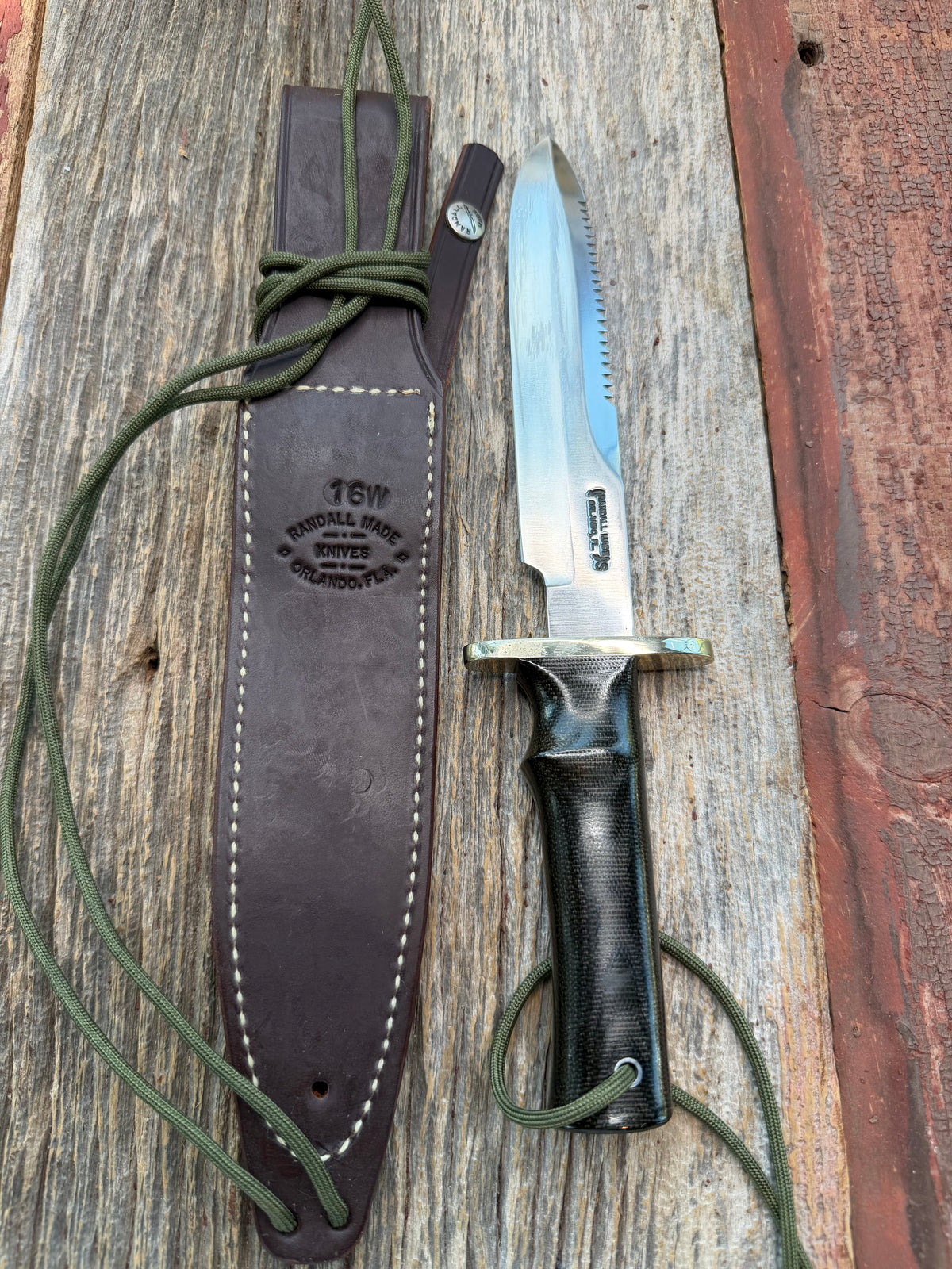 Nice Randall Model 16-7 with a glossy Brown Micarta handle. SS blade, double nickel silver hilt. Lanyard. Sawteeth, Brown waxed leather sheath.