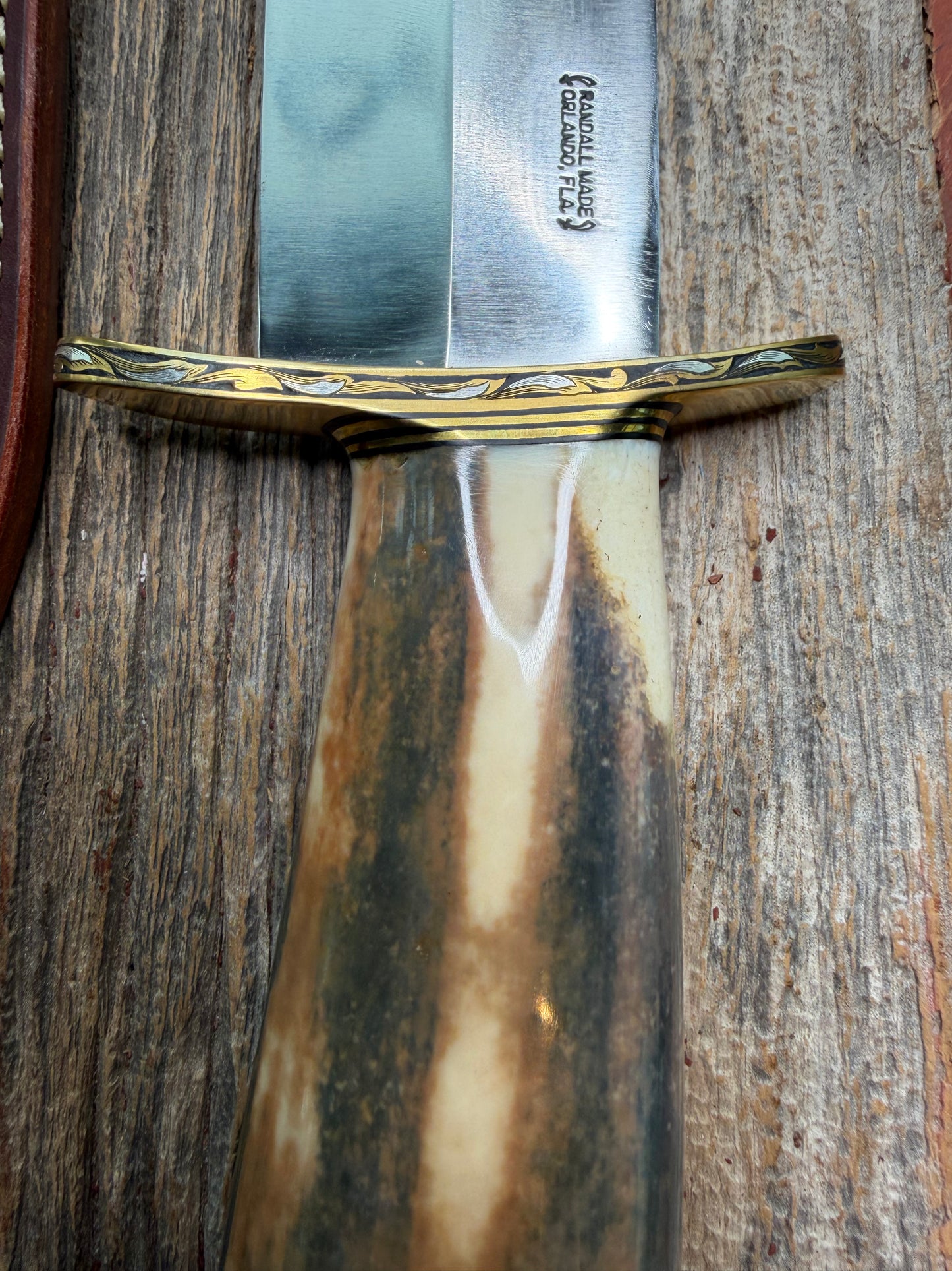 Randall Model 12-11 Smithsonian “Smitty” in a Huge piece of Green, Brown and Blue Fossil Walrus Ivory. Brass Hilt and Brass Butt plate fully engraved in Silver from Jere Davidson.  Stunning piece.