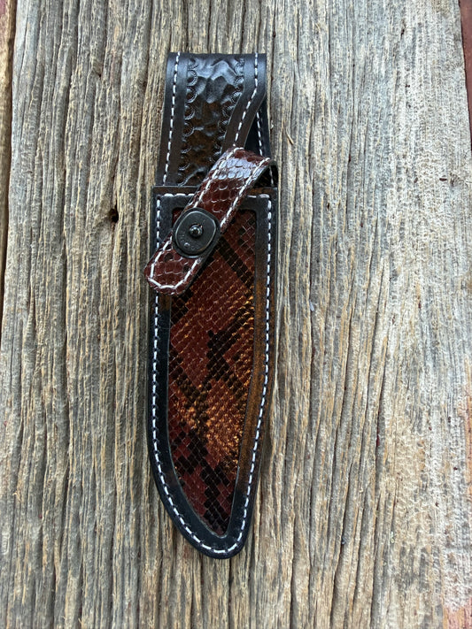 New Randall Model 1-6 Sheath in Exotic Brown Python Snake skin on black leather from Treeman with a black Canteen snap. Hand tooled belt loop. Deviated white stitching. Killer sheath.