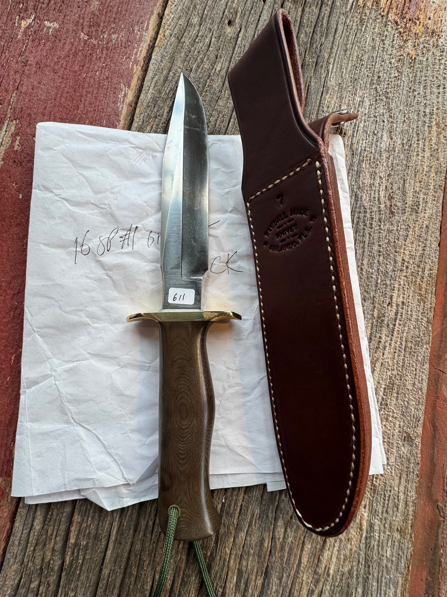 New in Paper Randall Model 16 SP#1 Special fighter with a Green Micarta handle. SS blade, Brass hilt. Lanyard. Brown leather sheath.