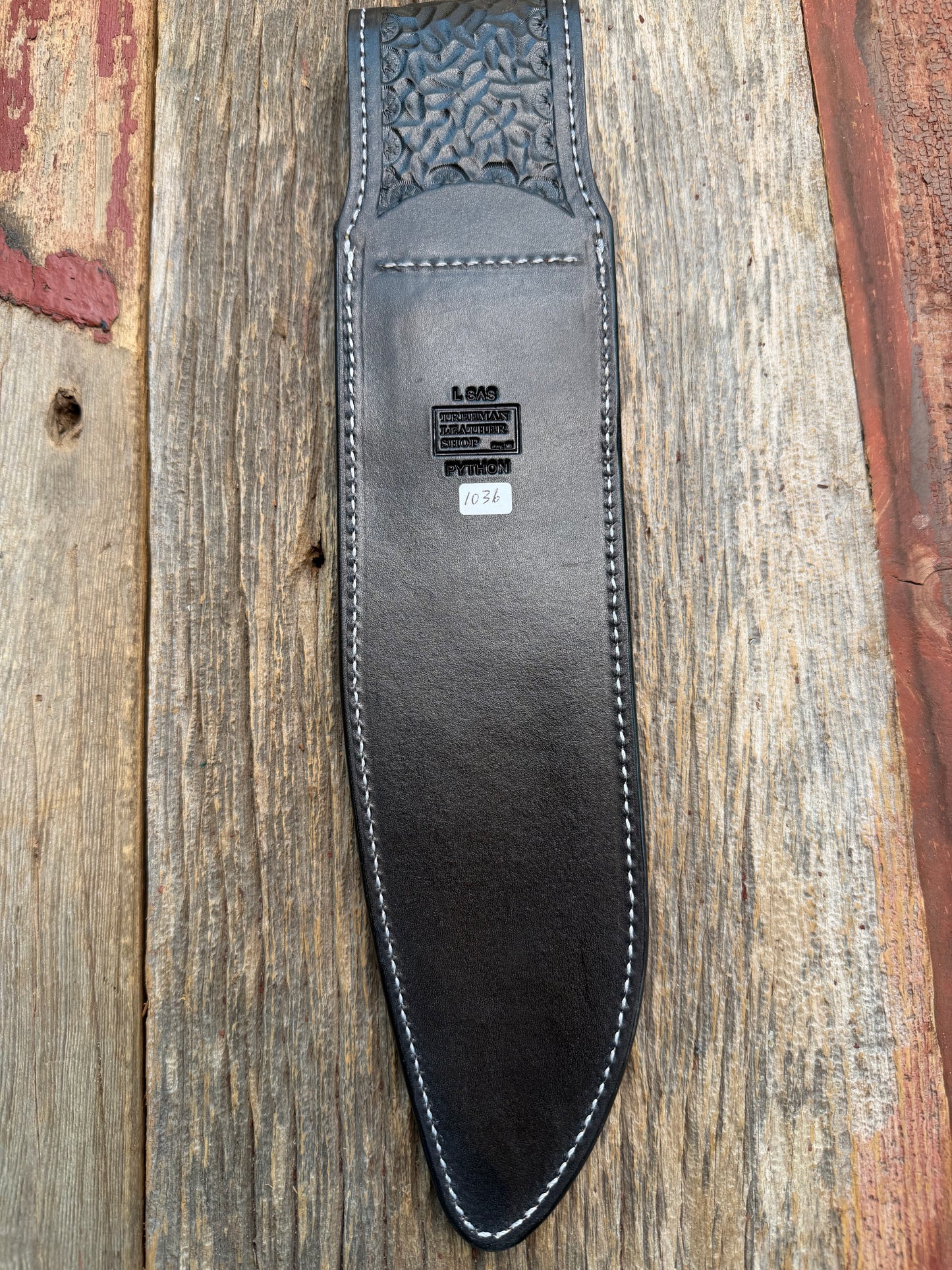 New Randall Model 12-11 Large Sasquatch Sheath in Exotic Brown Python Snake on black leather from Treeman with a black Canteen snap. Hand tooled belt loop. Deviated white stitching. Killer sheath.