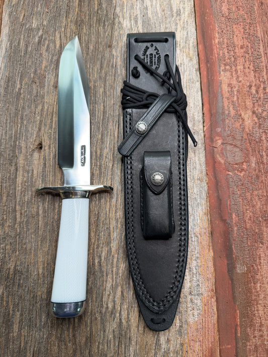 Randall Model 14-7.5 with a White Ivorite handle. Stainless steel blade, Nickel silver hilt and collar. Upgraded Black leather sheath.  Roundsd Aluminum butt cap.