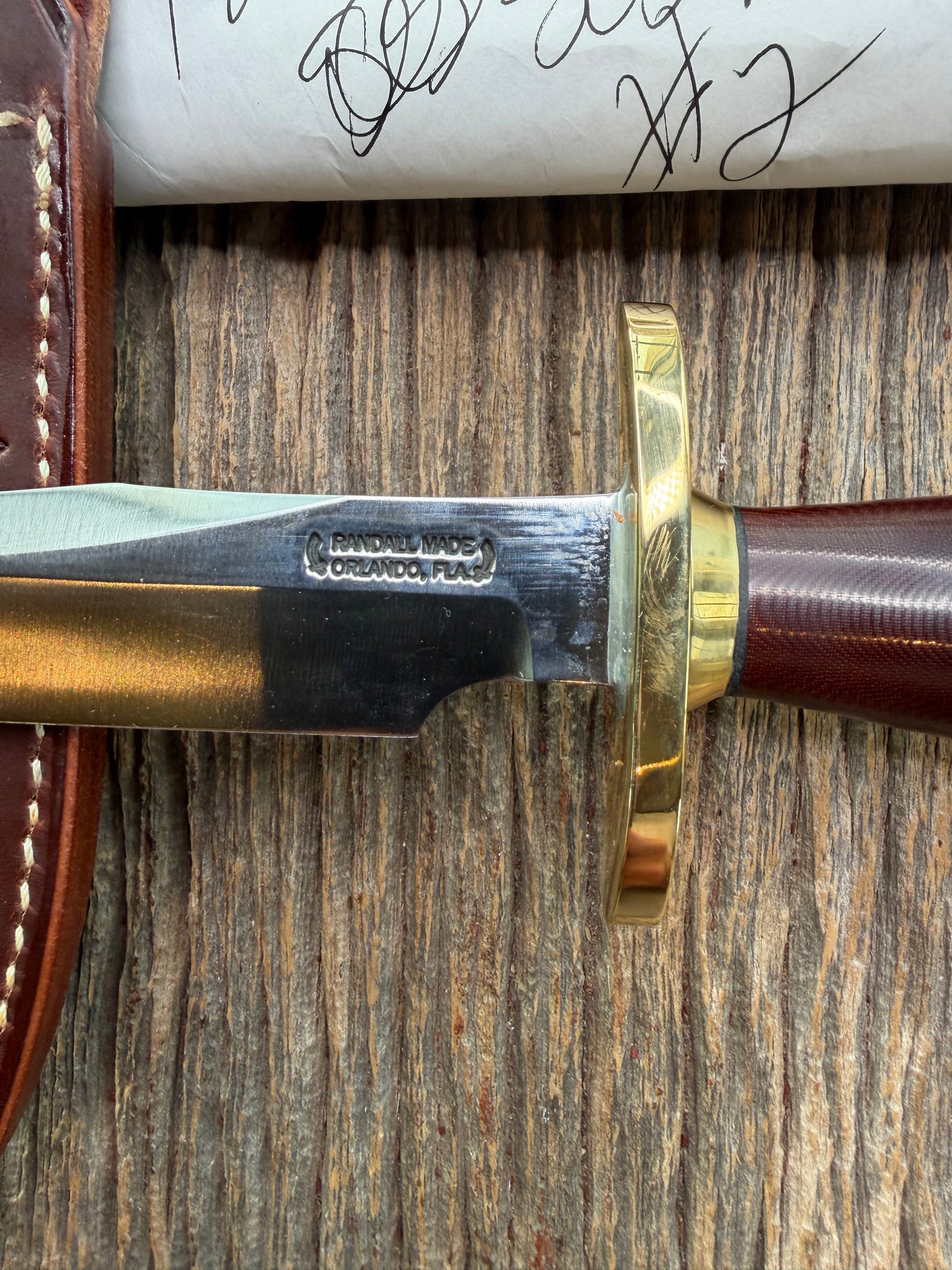 New in Paper Randall Model 12-6 Little Bear with a Maroon Micarta handle. Brass Hilt  and Brass collar Carbon steel, natural end.