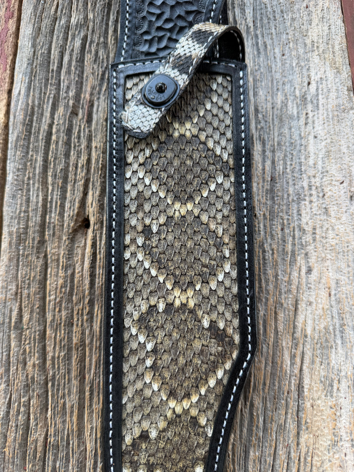 Randall Model Smithsonian sheath with a Western Diamondback RattleSnake skin inlay from Treeman Sheaths. Very dark skin, white thread deviated stitching, black canteen snap.