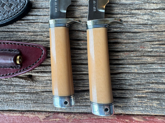 A pair of Randall Stanaback Specials in Bone Linen Micarta. A large and the small Stanaback with a 4 and a 4 1/2” Stainless steel Blade, Nickel Silver Single Hilt with Aluminum & Black Spacers. Nickel silver butt caps and a Lanyard. Special Edition